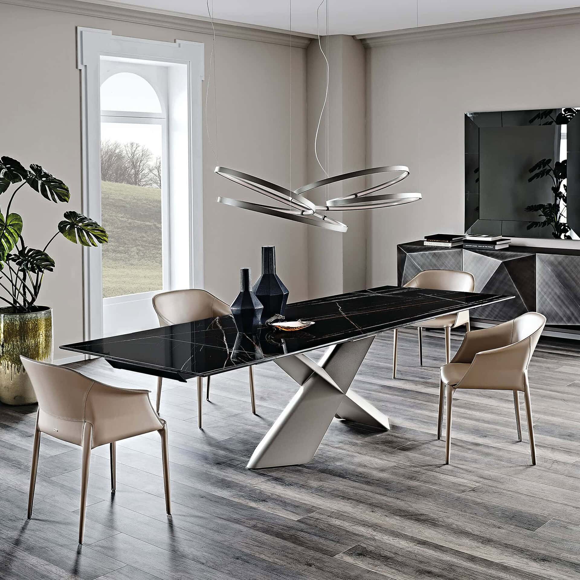 Modern black marble dining table with unique metallic base and contemporary seating.