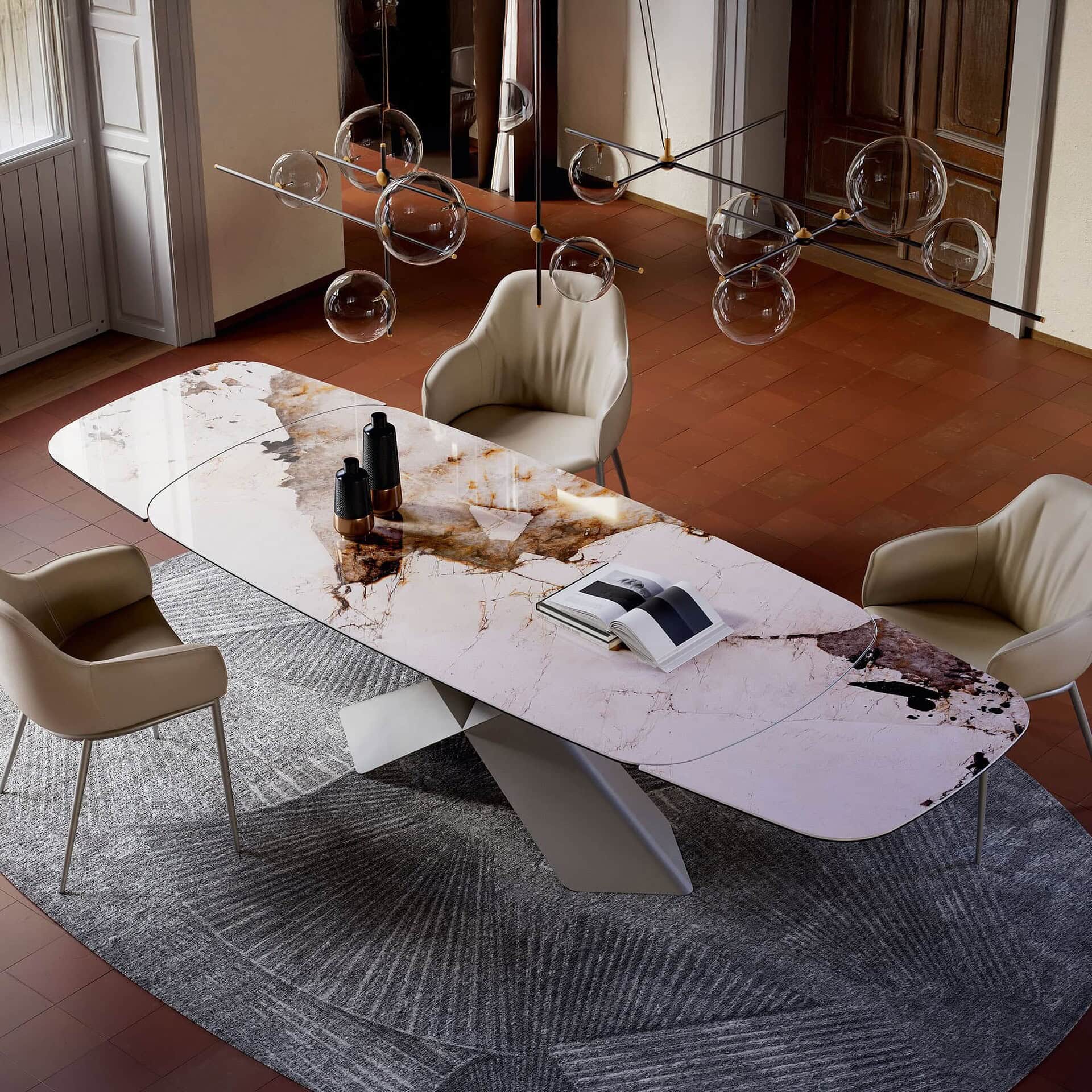 Elegant marble dining table with modern chairs, stylish lighting, and decor in a contemporary interior.