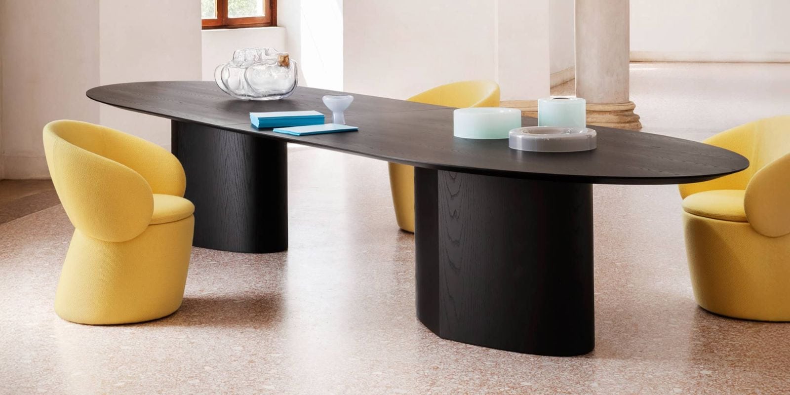 Elegant black wood dining table with yellow upholstered chairs, modern decor for stylish home dining. The Monoplauto Maxxxi Dining Table