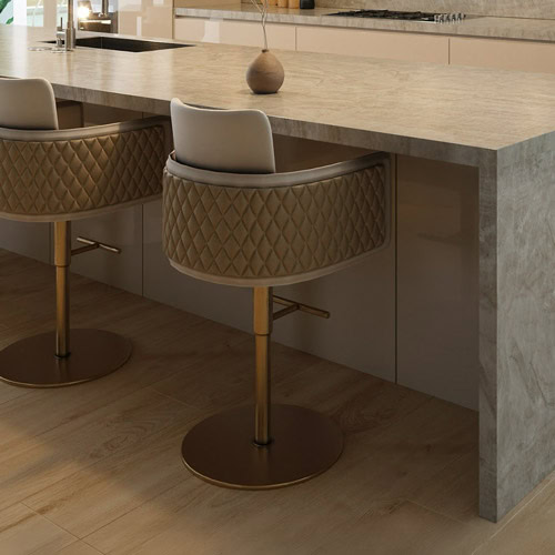 Luxurious quilted barstool with plush padding and gold accents, perfect for modern kitchens.