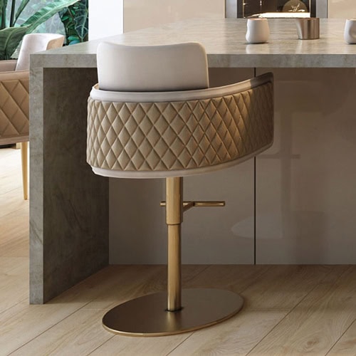 Luxurious quilted barstool with plush padding and gold accents, perfect for modern kitchens.