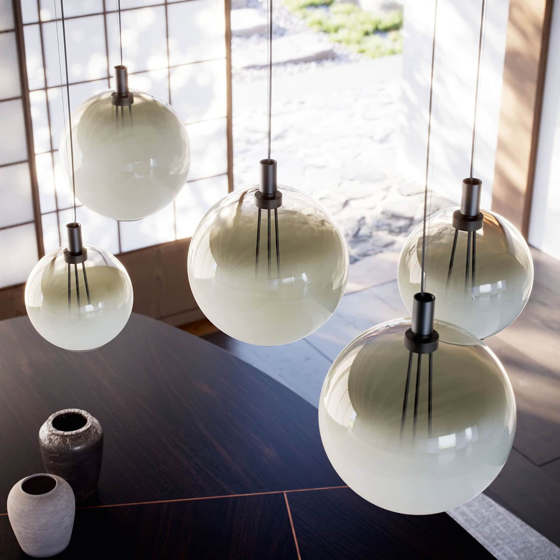 Sleek modern pendant lighting hangs above a dining table in a stylish interior.