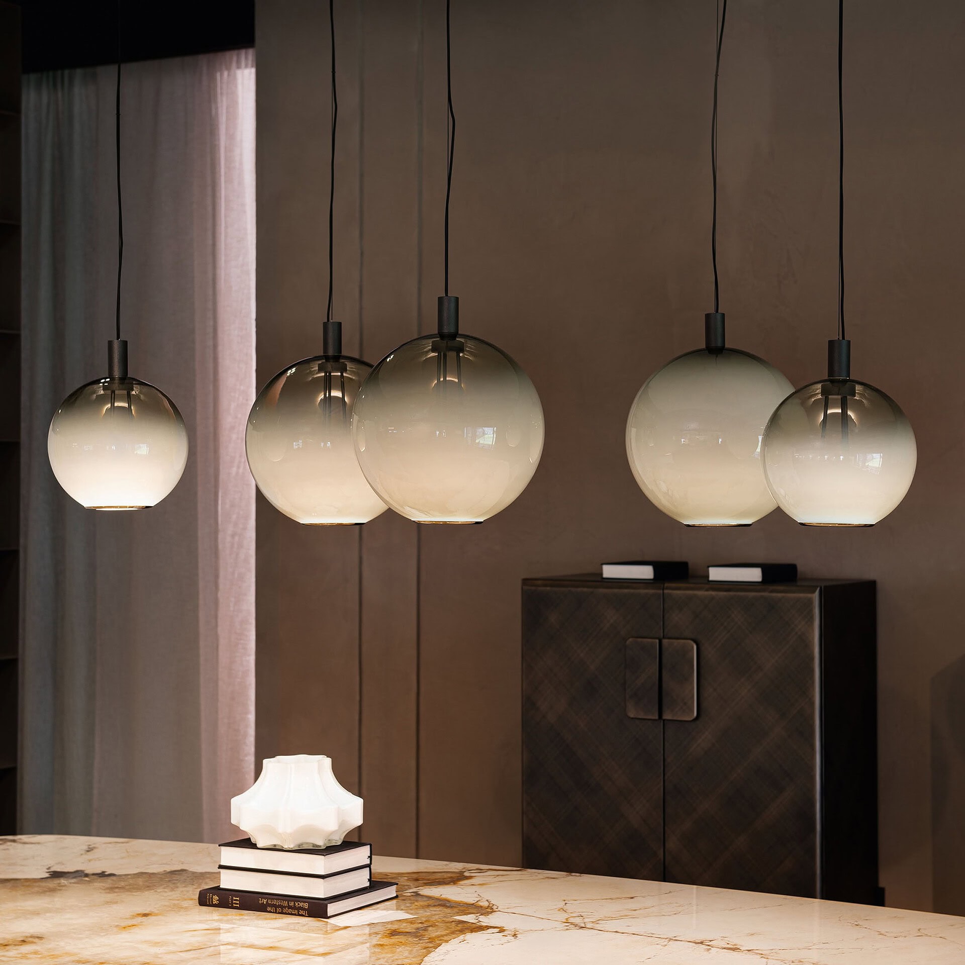 Contemporary glass pendant light fixtures in a modern dining room setting.