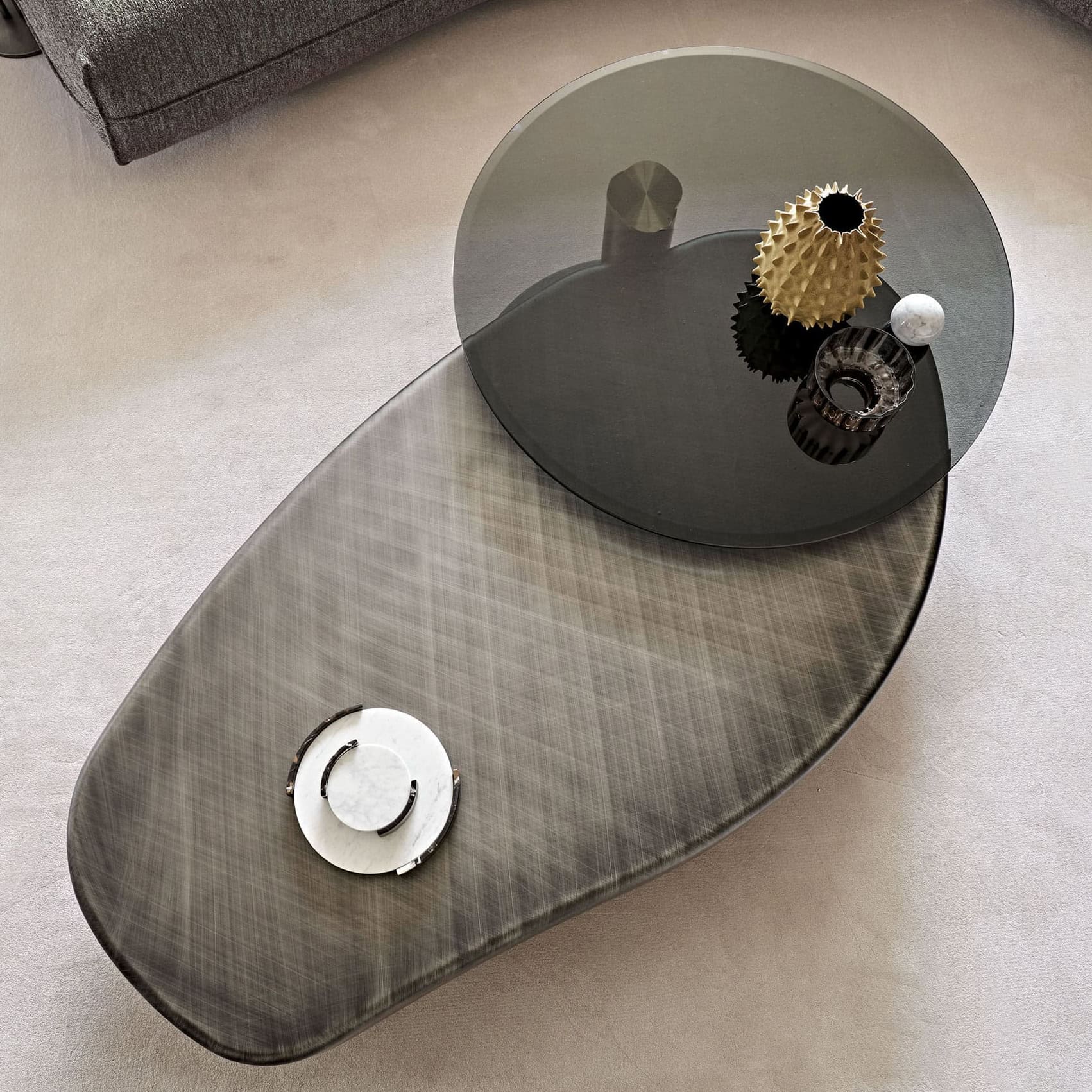 Modern glass and metal coffee table with decorative vases, perfect for contemporary living rooms.