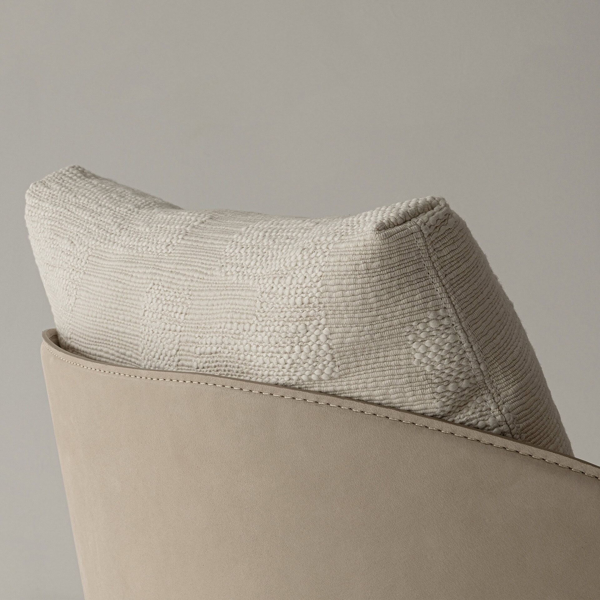 Soft beige textured sofa pillow with woven pattern for modern home decor.