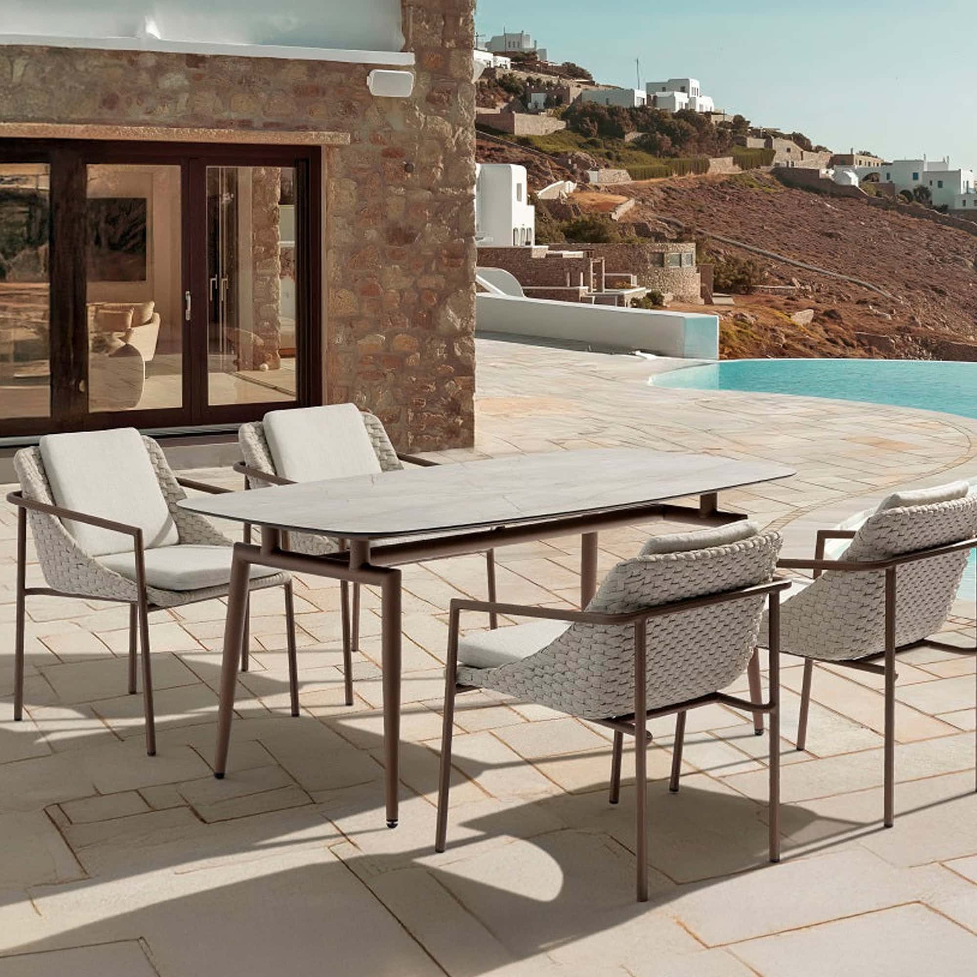 Modern outdoor coffee table with marble top by Sklar Furnishings.