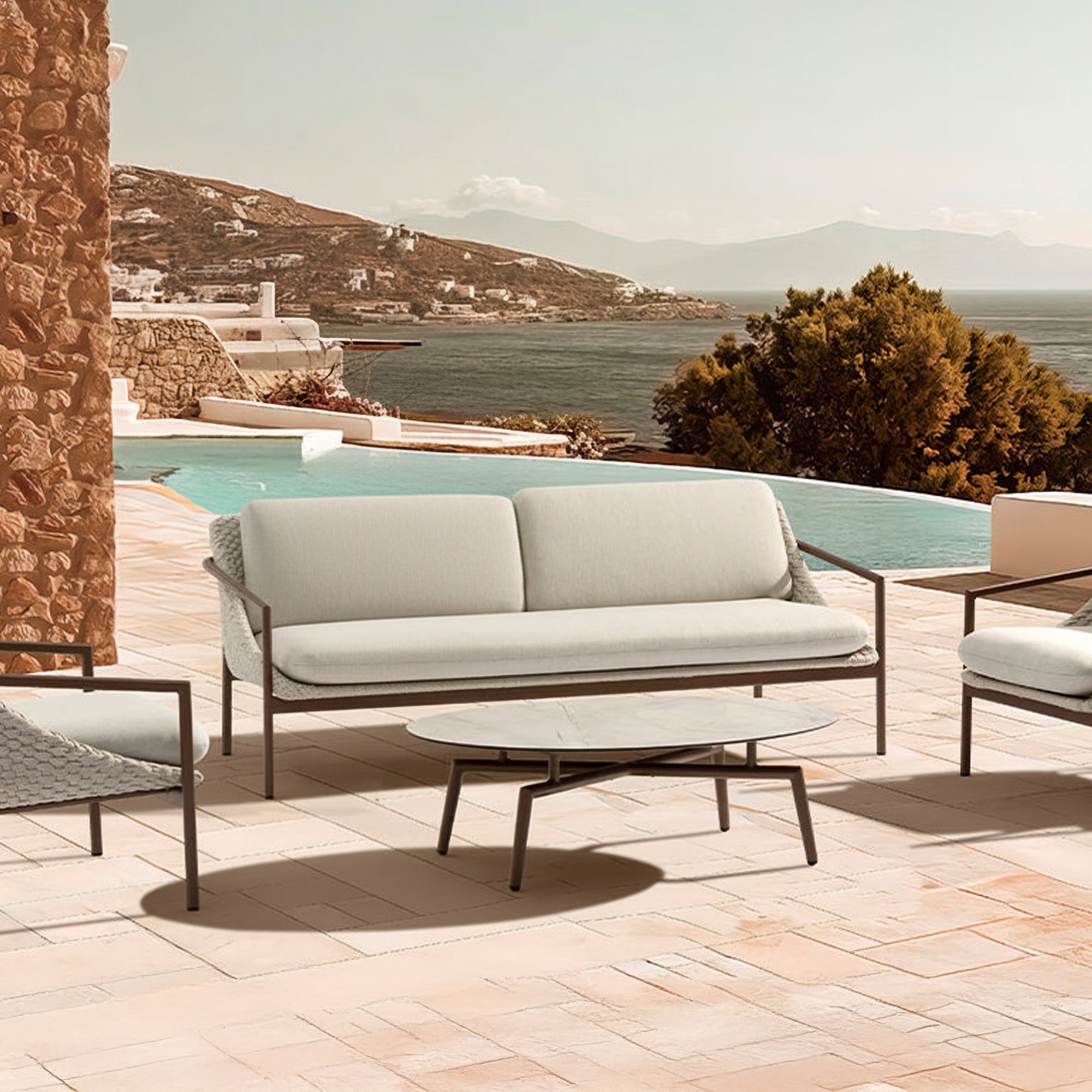 Modern outdoor sofa with beige cushions and rust-colored pillows in a sunroom.