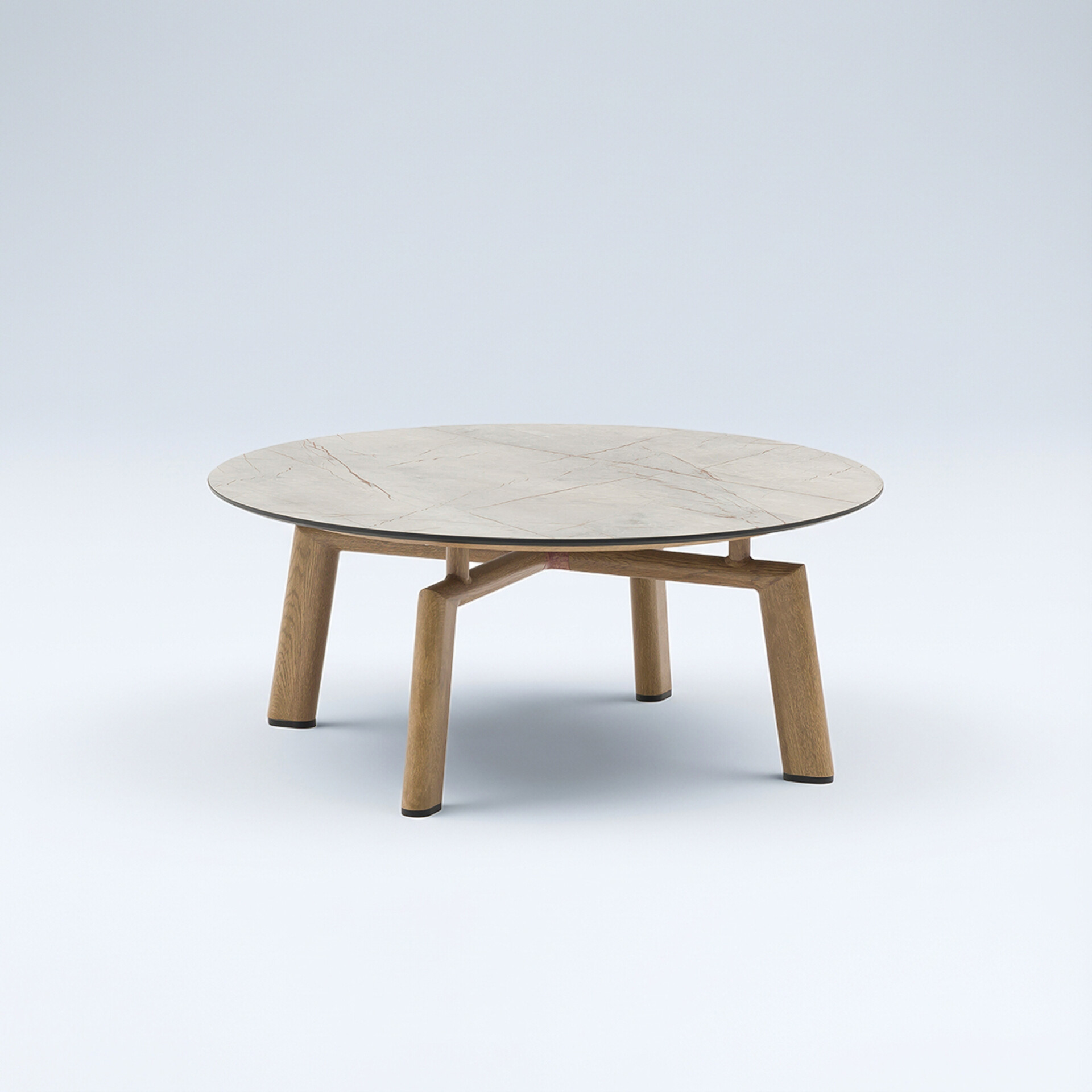 A round coffee table with a light marble-patterned top and a light wooden base with four angled legs, set against a plain light background.