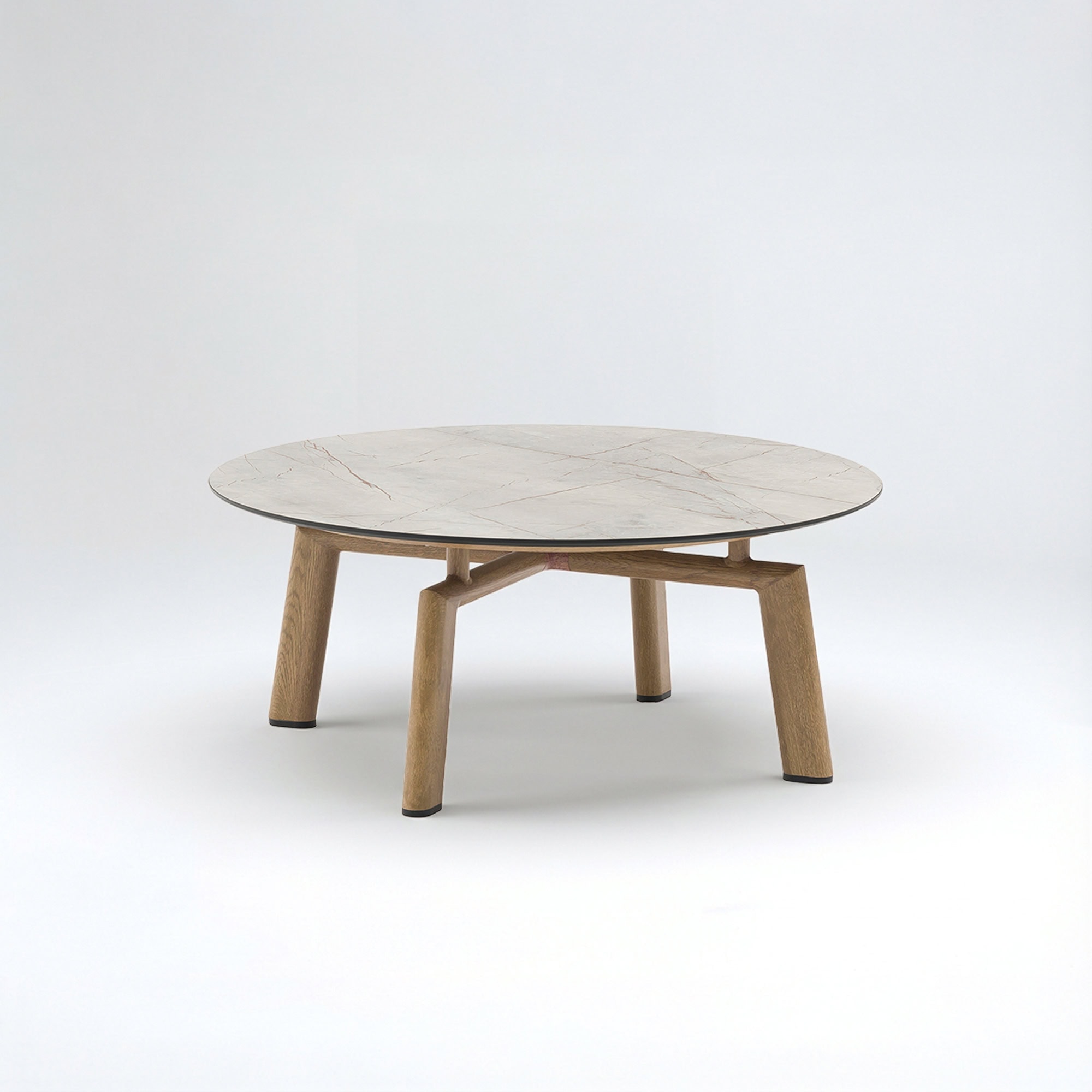 A round coffee table with a light marble-patterned top and a light wooden base with four angled legs, set against a plain light background.