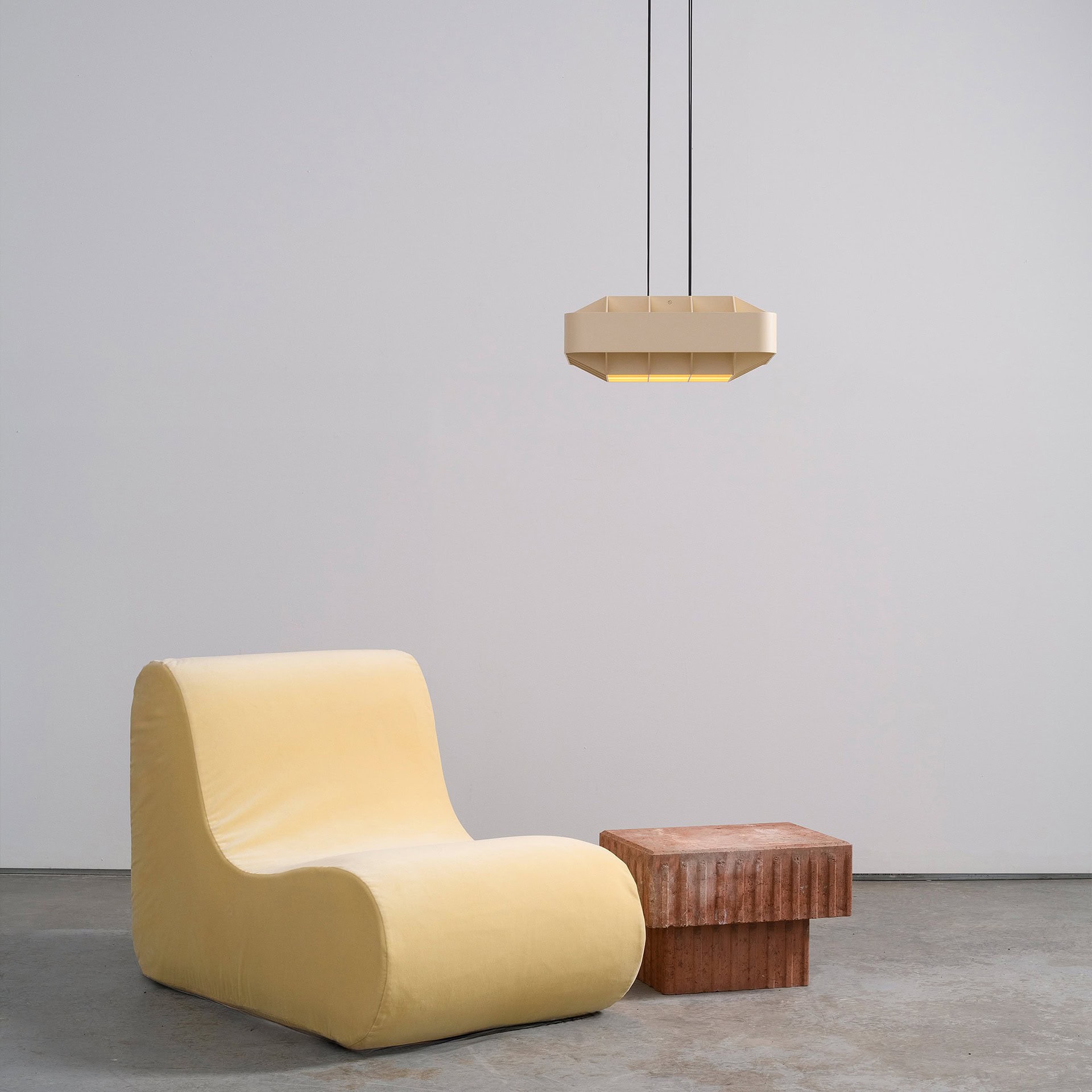 Stylish yellow modern lounge chair with a matching side table in a minimalist interior.