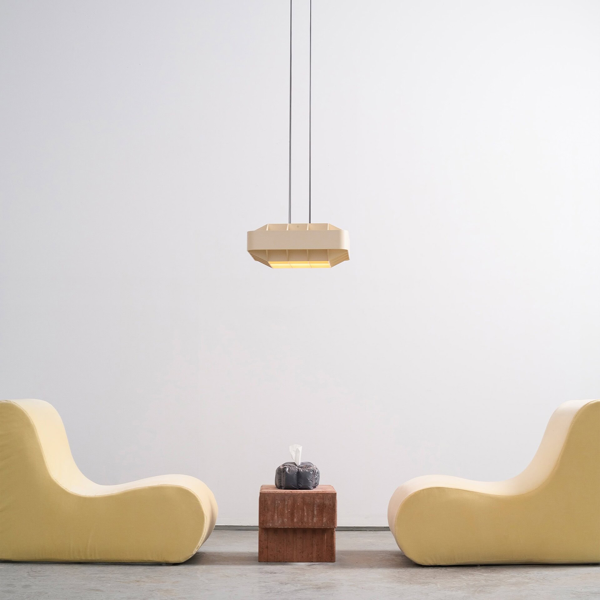 Contemporary minimalist seating area with unique yellow modern lounge chairs and a wooden side table.