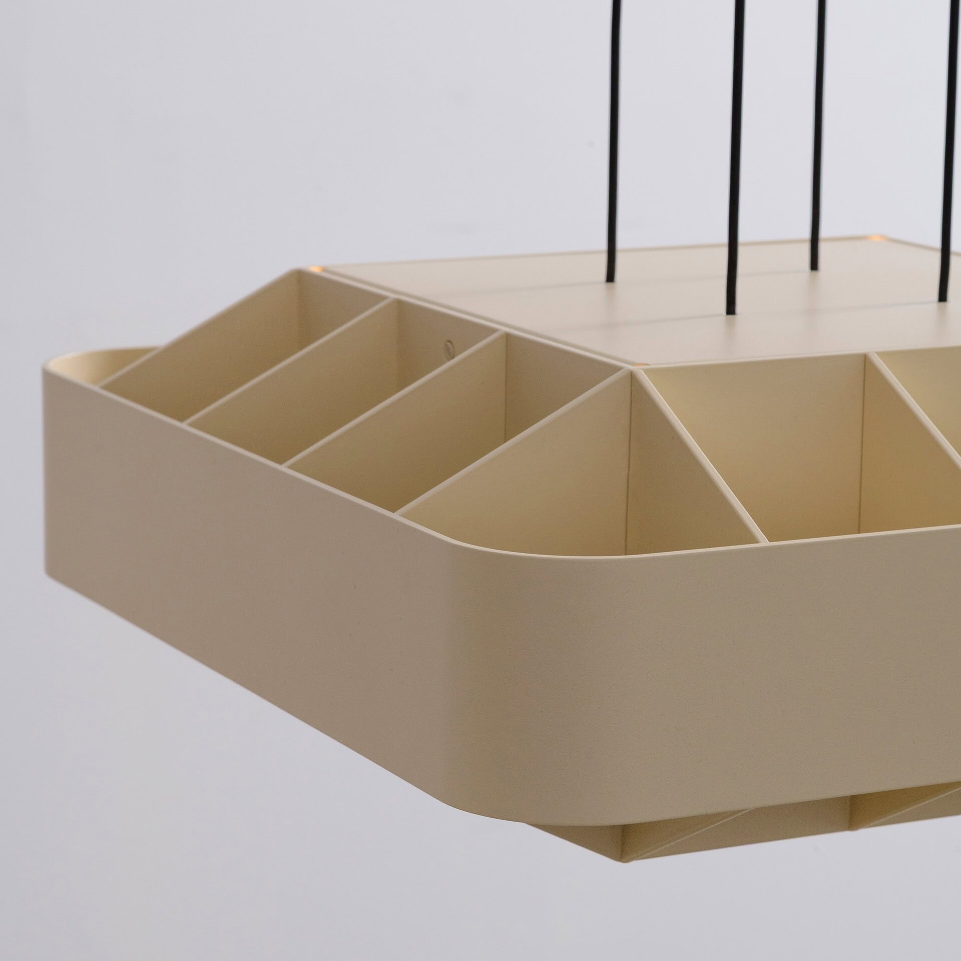 Modern beige storage unit with multiple compartments and black metal rods, designed by Sklar Furnishings.