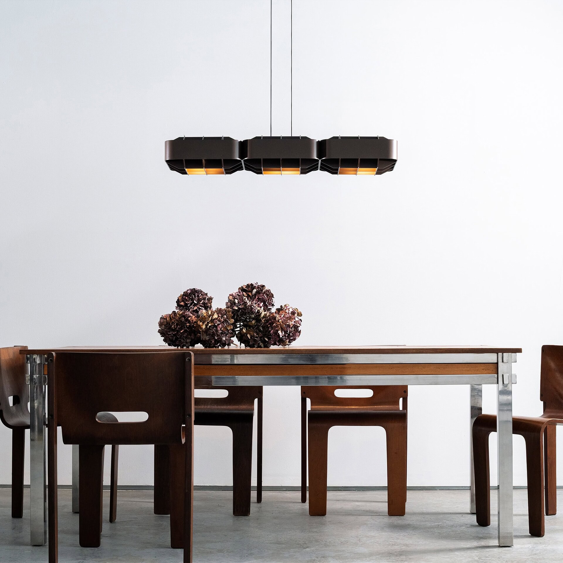 Black modern pendant light fixture over dining table.
