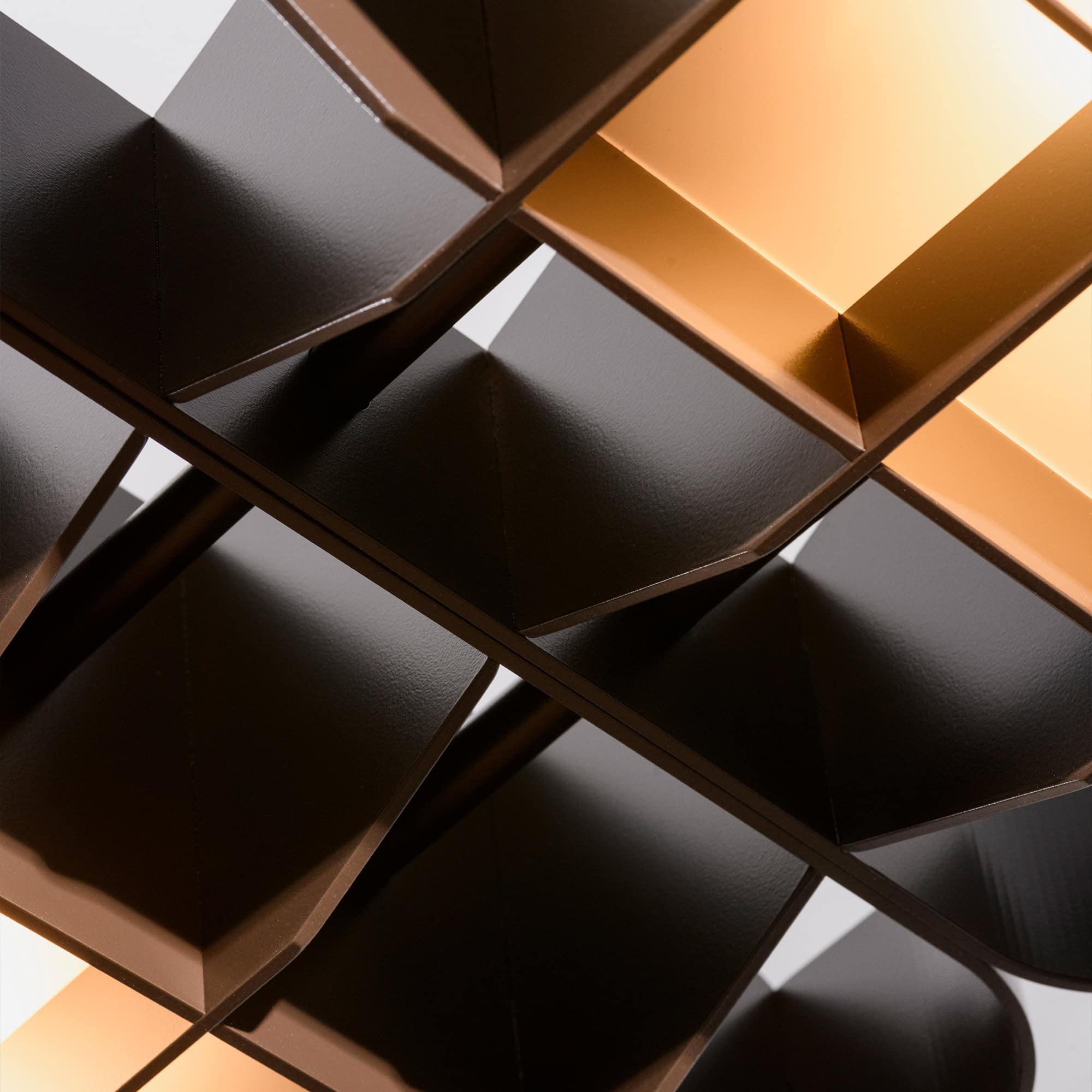 Contemporary shelving unit with warm lighting and sleek dark finish for modern interior decor.