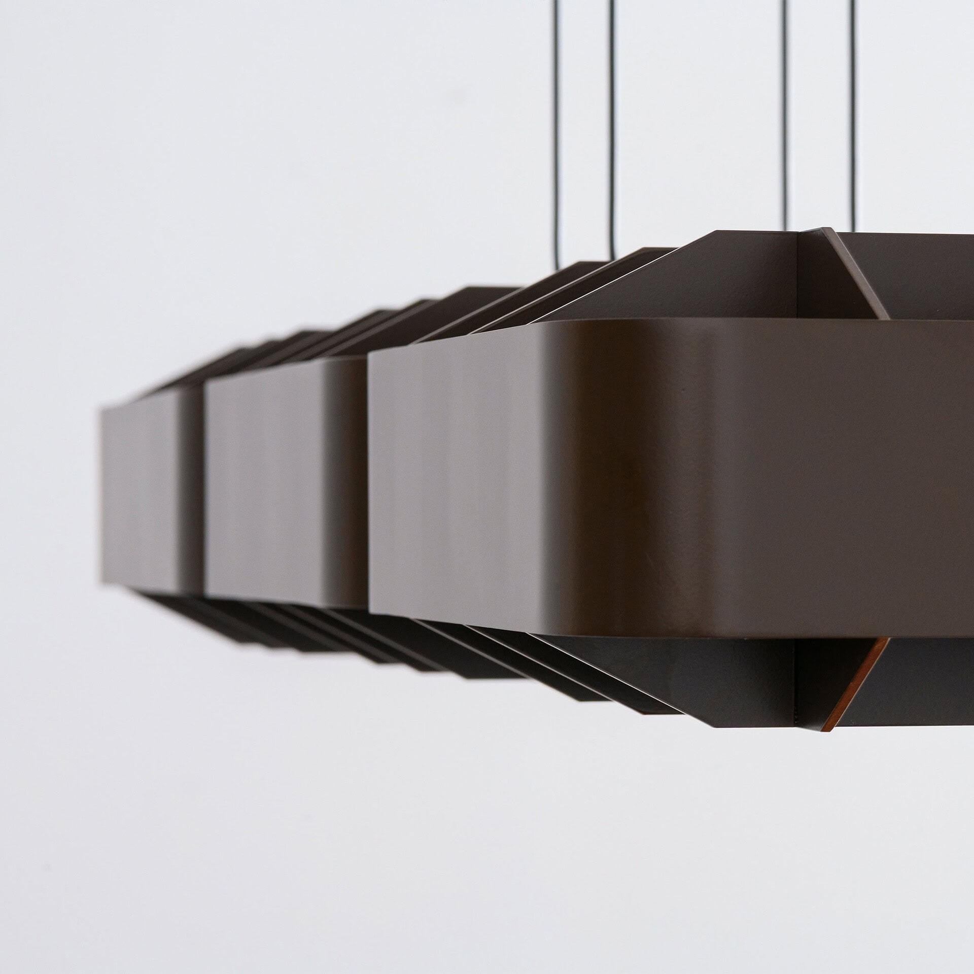Contemporary brown pendant light fixture with geometric design, sleek finish, and modern style for upscale interiors.