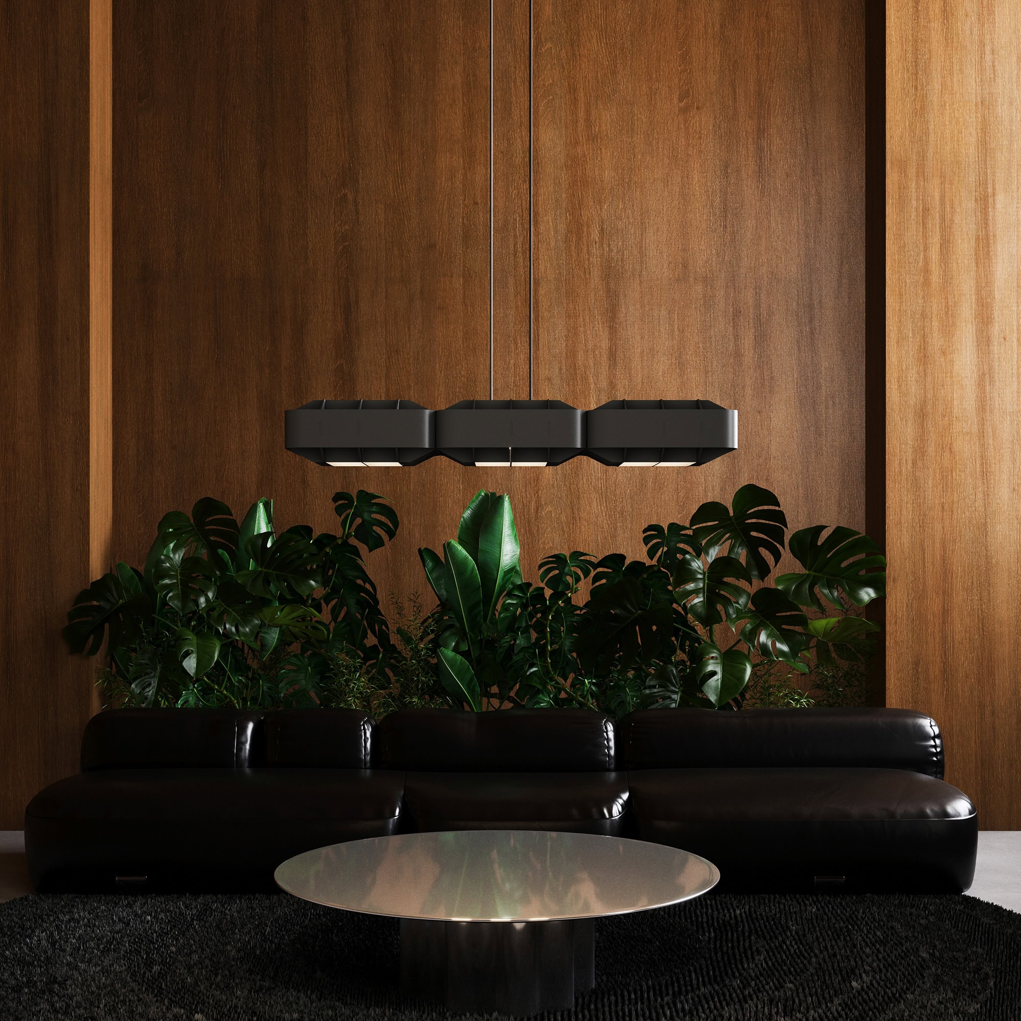 Sleek black leather sofa with lush green plants and modern lighting in a stylish interior.