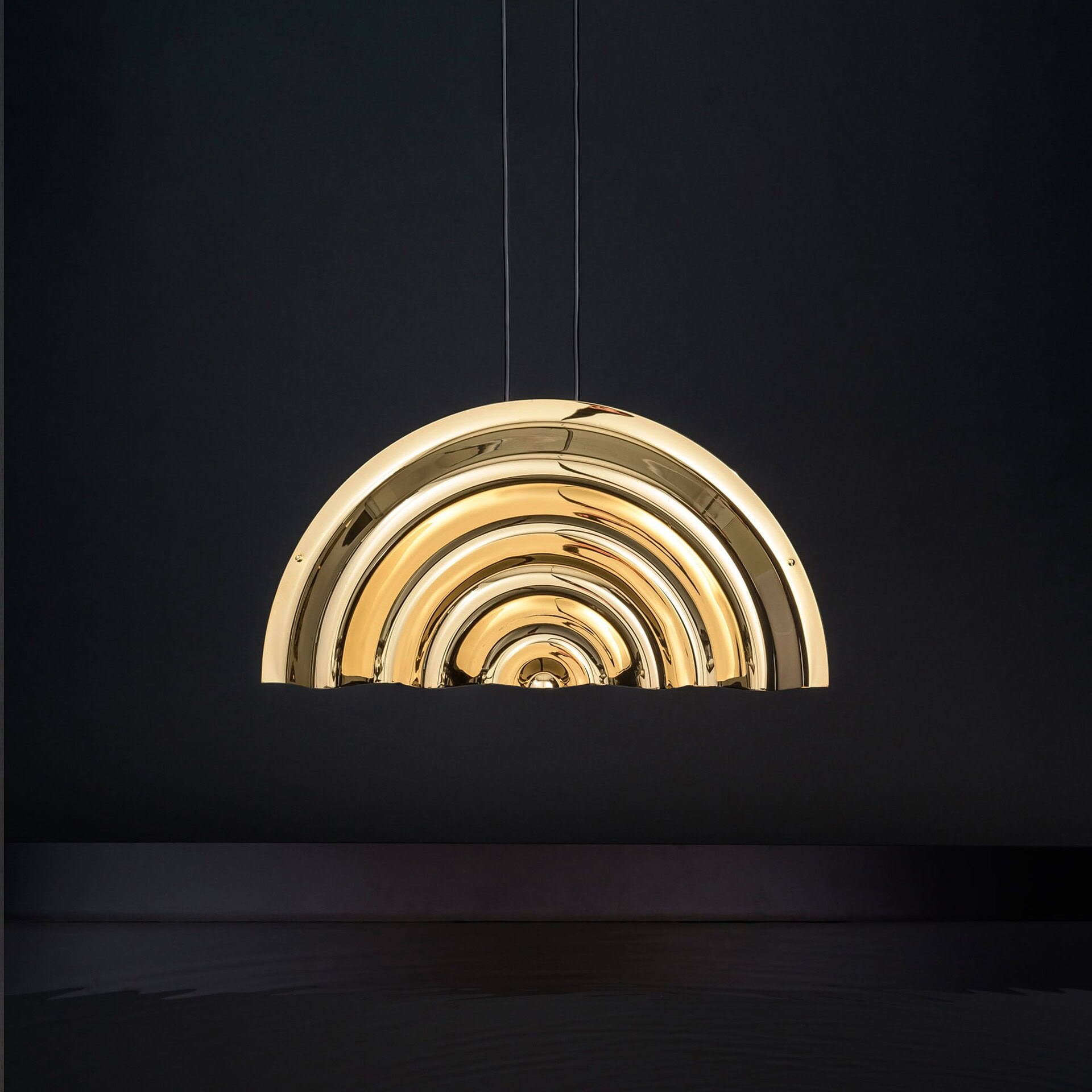 Brass pendant light fixture with concentric semi-circle design, modern lighting for interior decor.