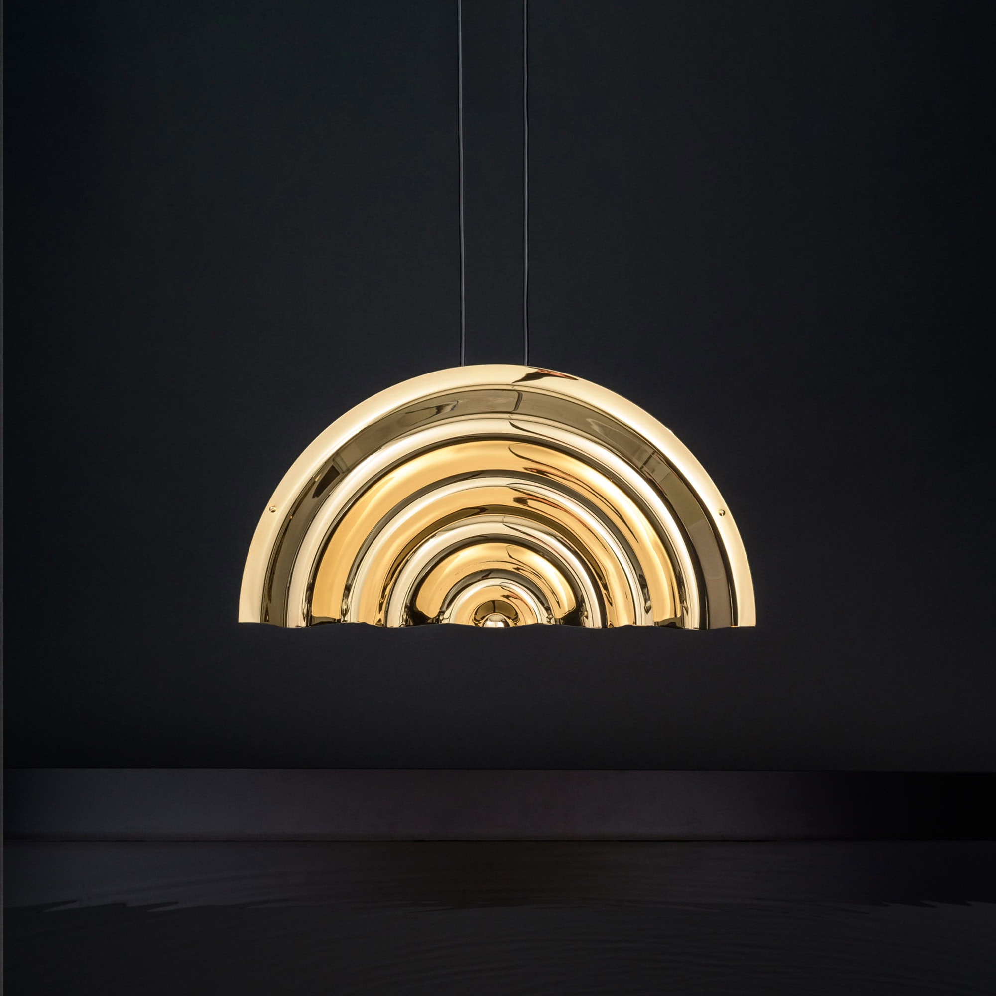 Brass pendant light fixture with concentric semi-circle design, modern lighting for interior decor.