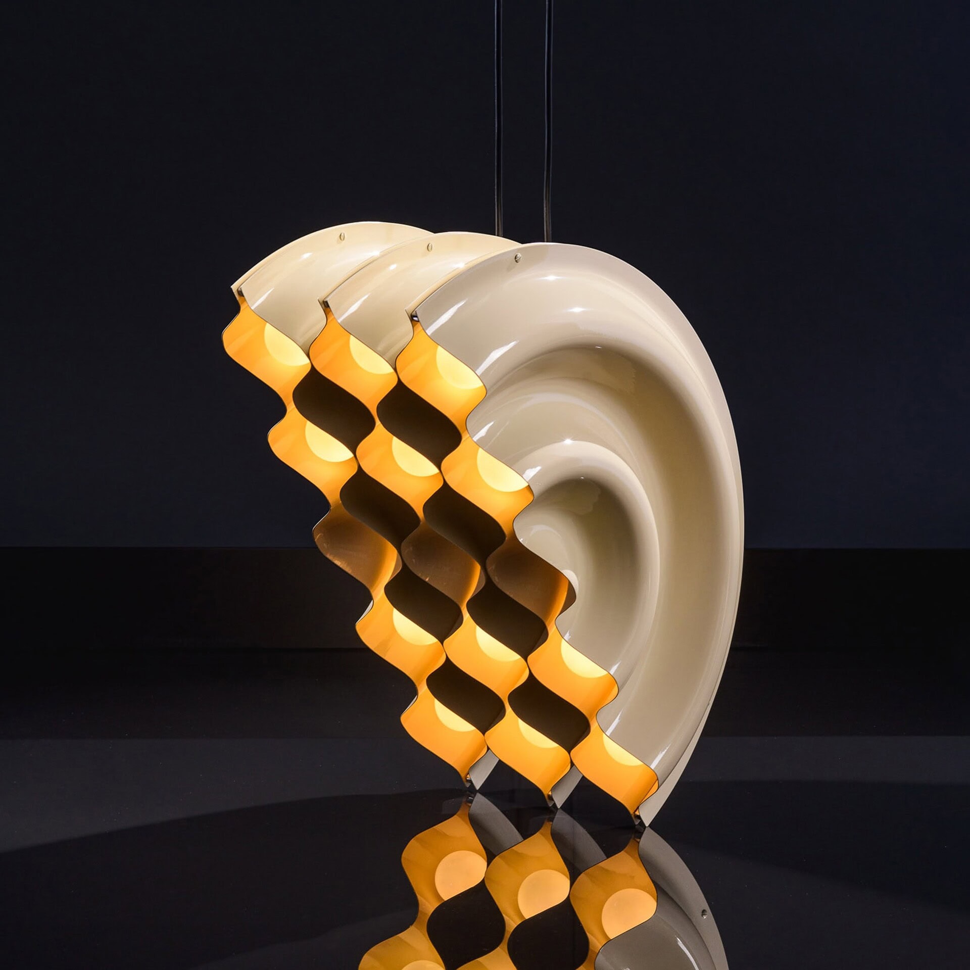 Contemporary sculptural pendant light with wavy design, ideal for modern interior decor.