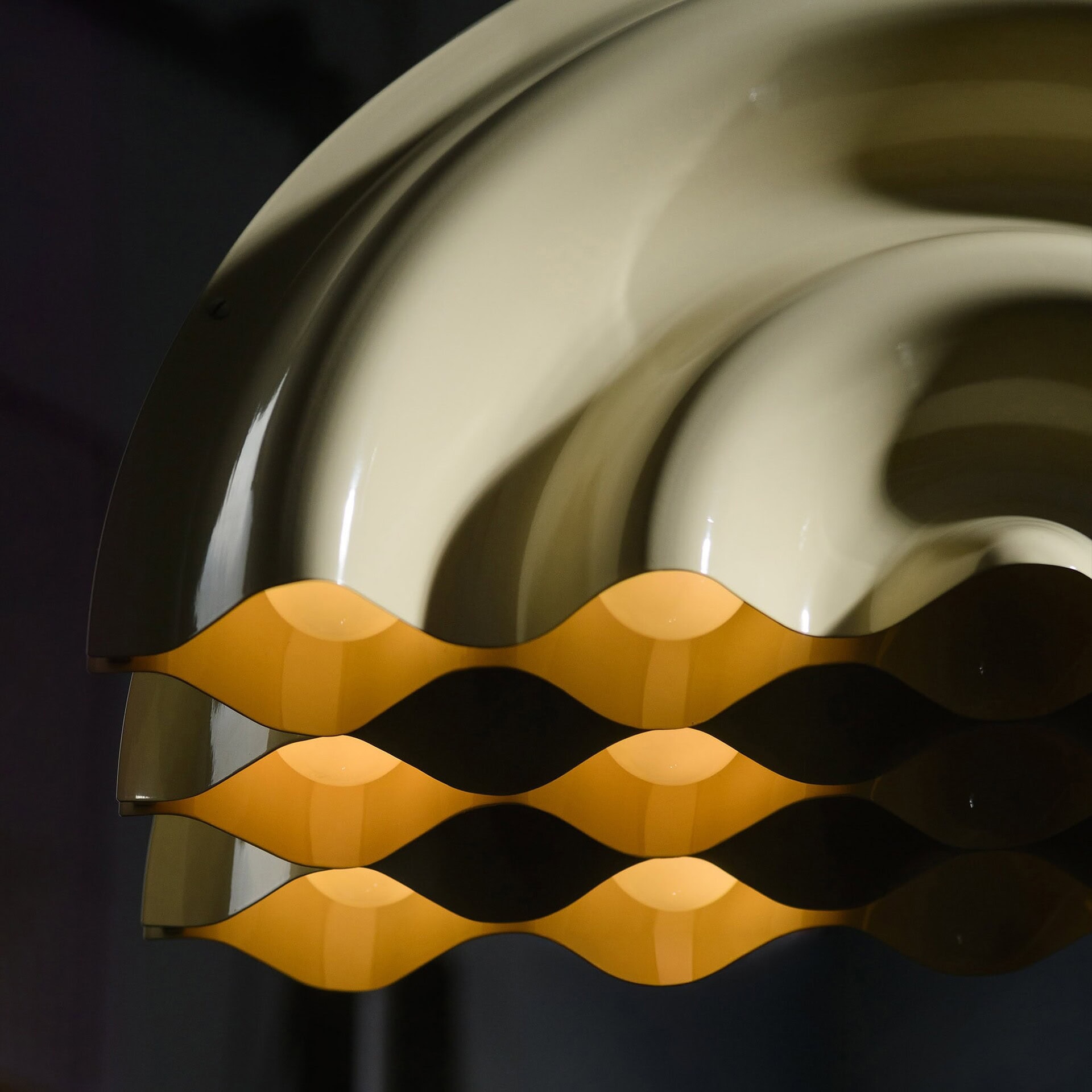 Streamlined modern lighting fixture with wave design, high-quality craftsmanship from Sklar Furnishings.