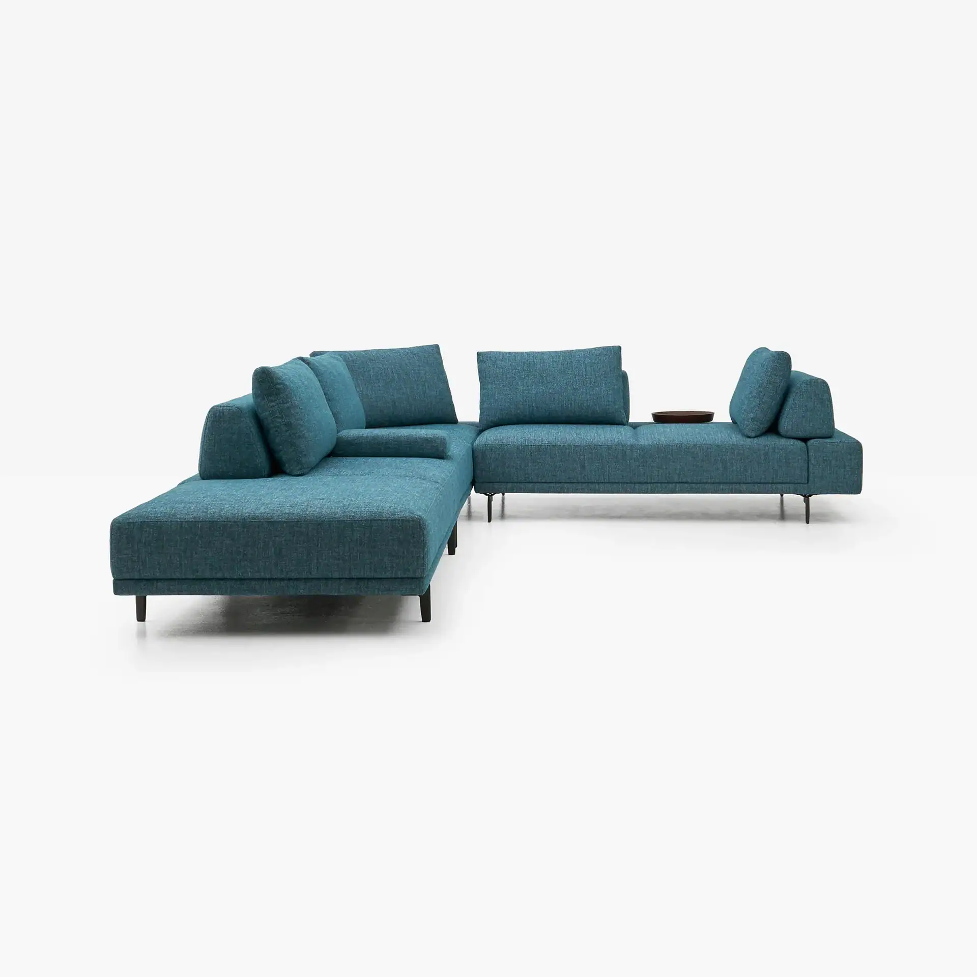 A modern L-shaped sectional sofa in textured teal fabric with dark legs, featuring a wooden tray on the backrest, against a white background.