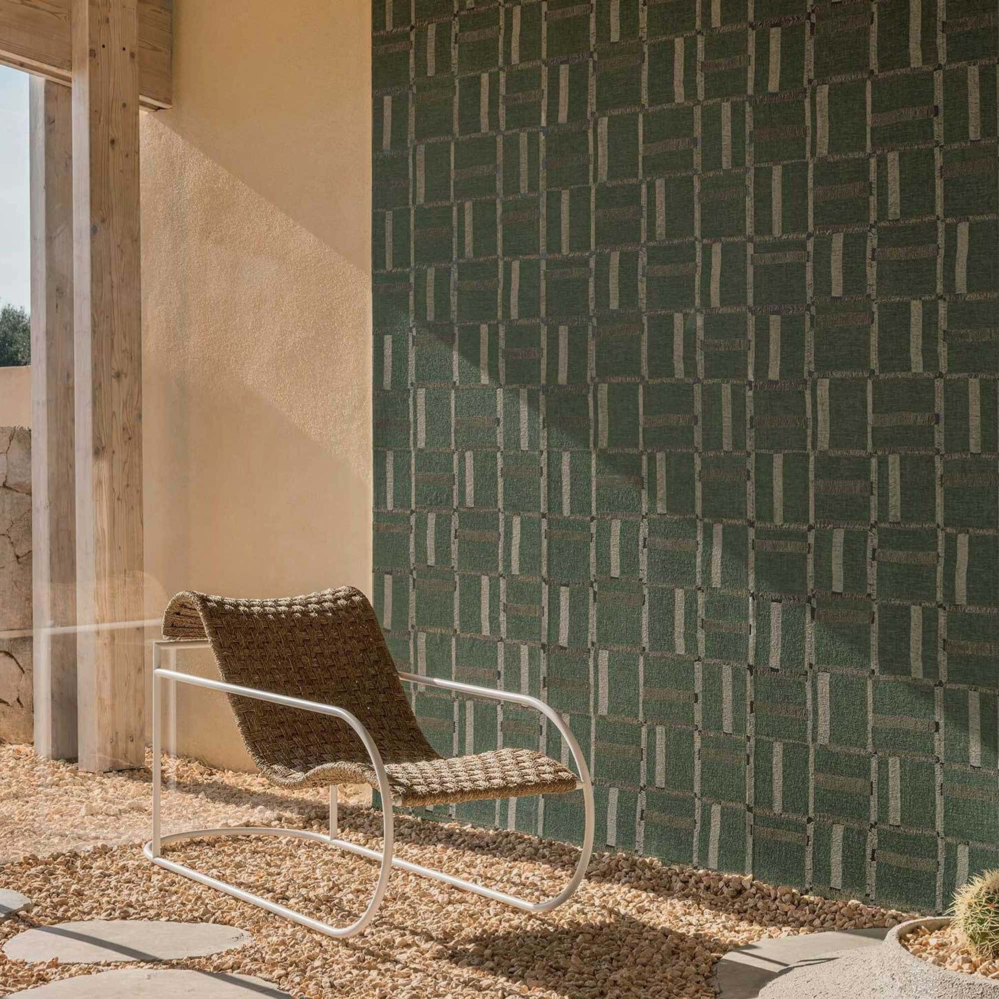 Élitis Cybèle wallpaper in muted green tones, showcasing a linen-inspired grid pattern under soft natural light.