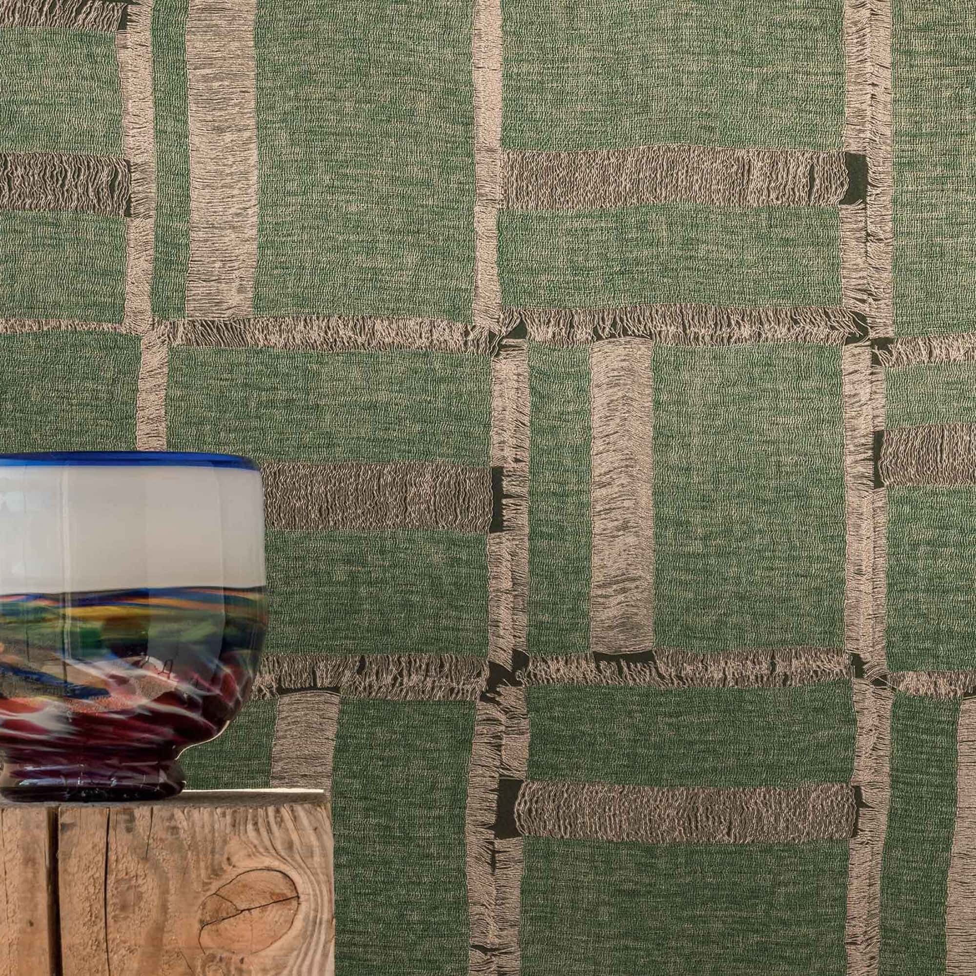 Close-up of Élitis Cybèle wallpaper in deep green, highlighting tactile vinyl texture and handwoven detailing.