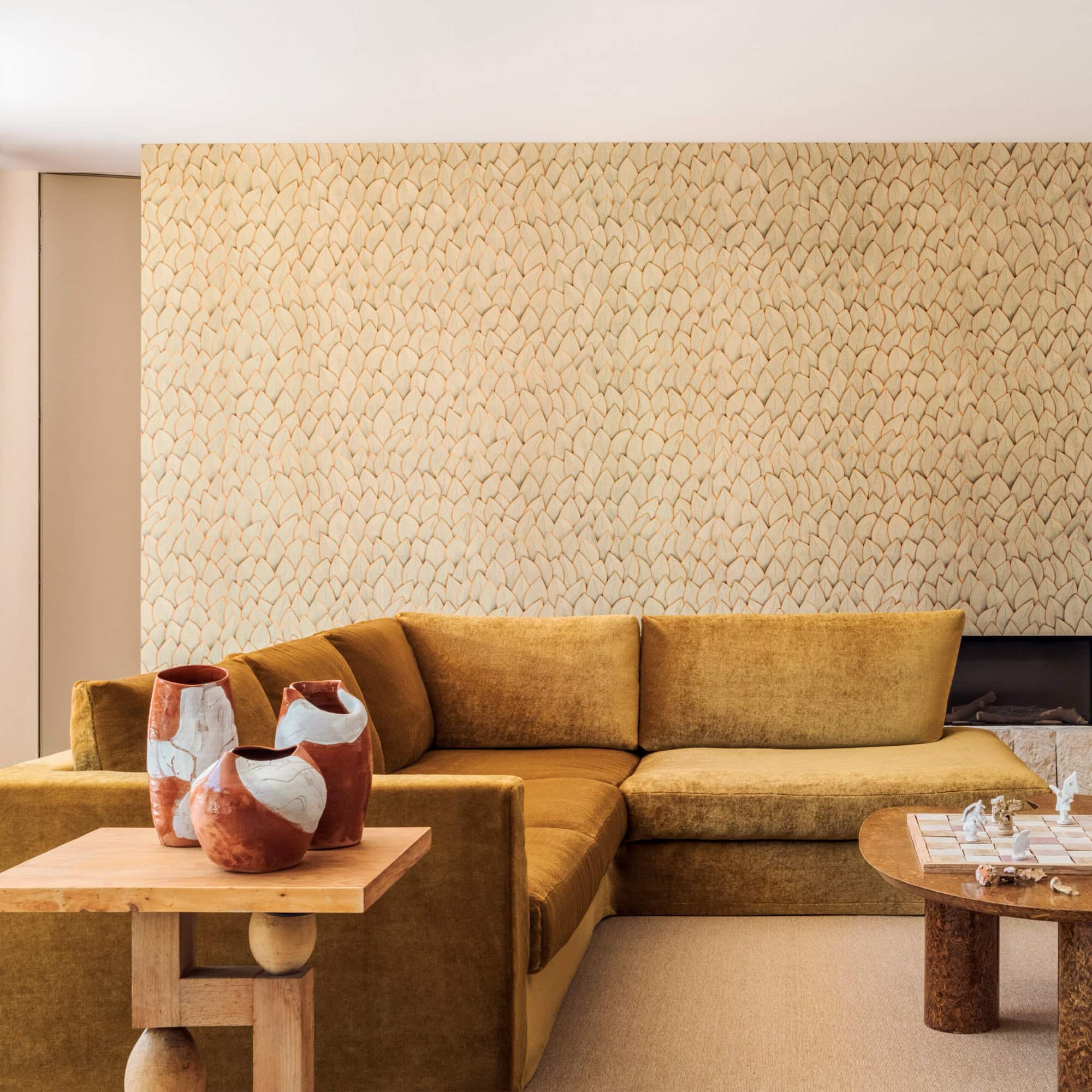 Vibrant mustard sectional sofa with decorative vase arrangement in modern living room.