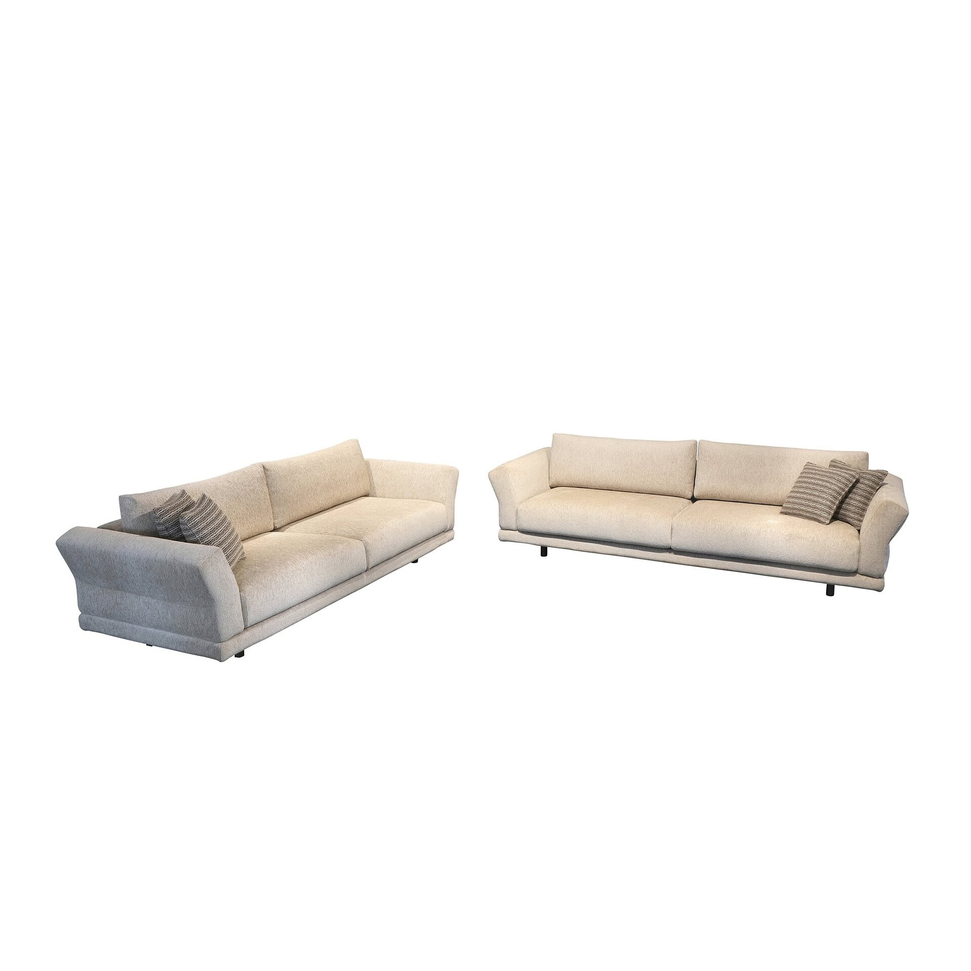 Sleek modern beige sofas with striped accent pillows, stylish living room furniture.