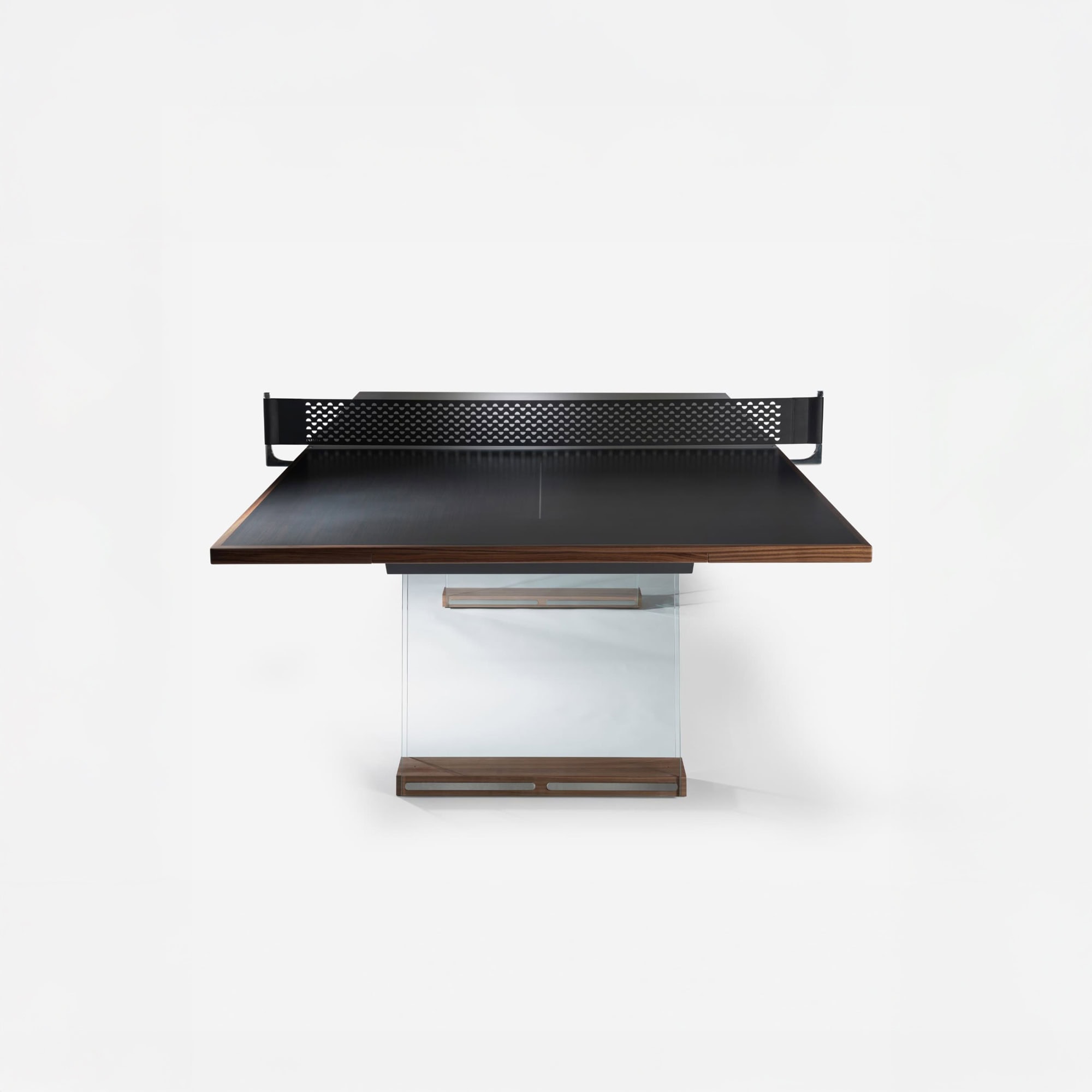 Contemporary dining table with a dark wood surface, glass base, and perforated black metal privacy panel.