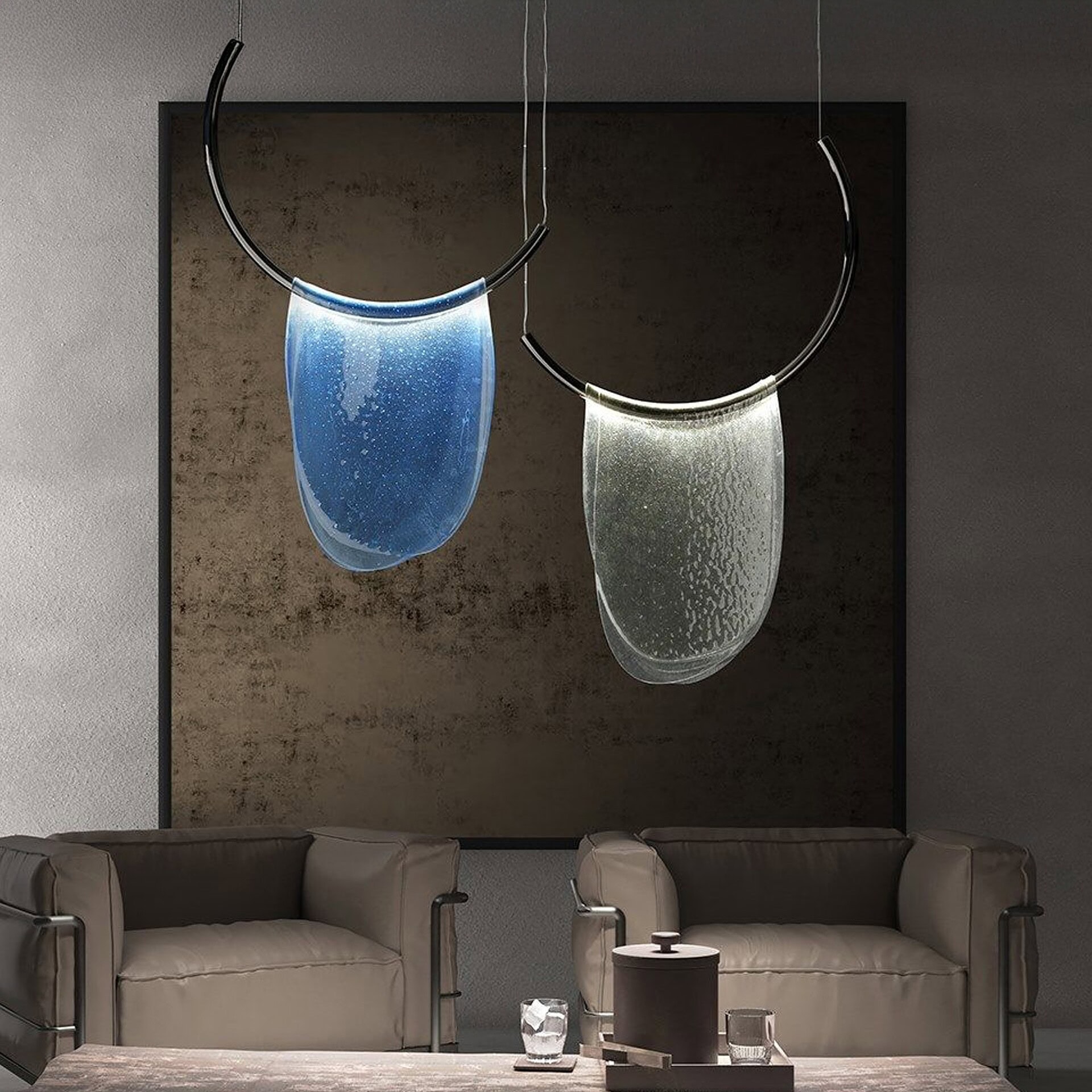 Stylish modern glass art pendant lights over beige leather sofas in contemporary living room.