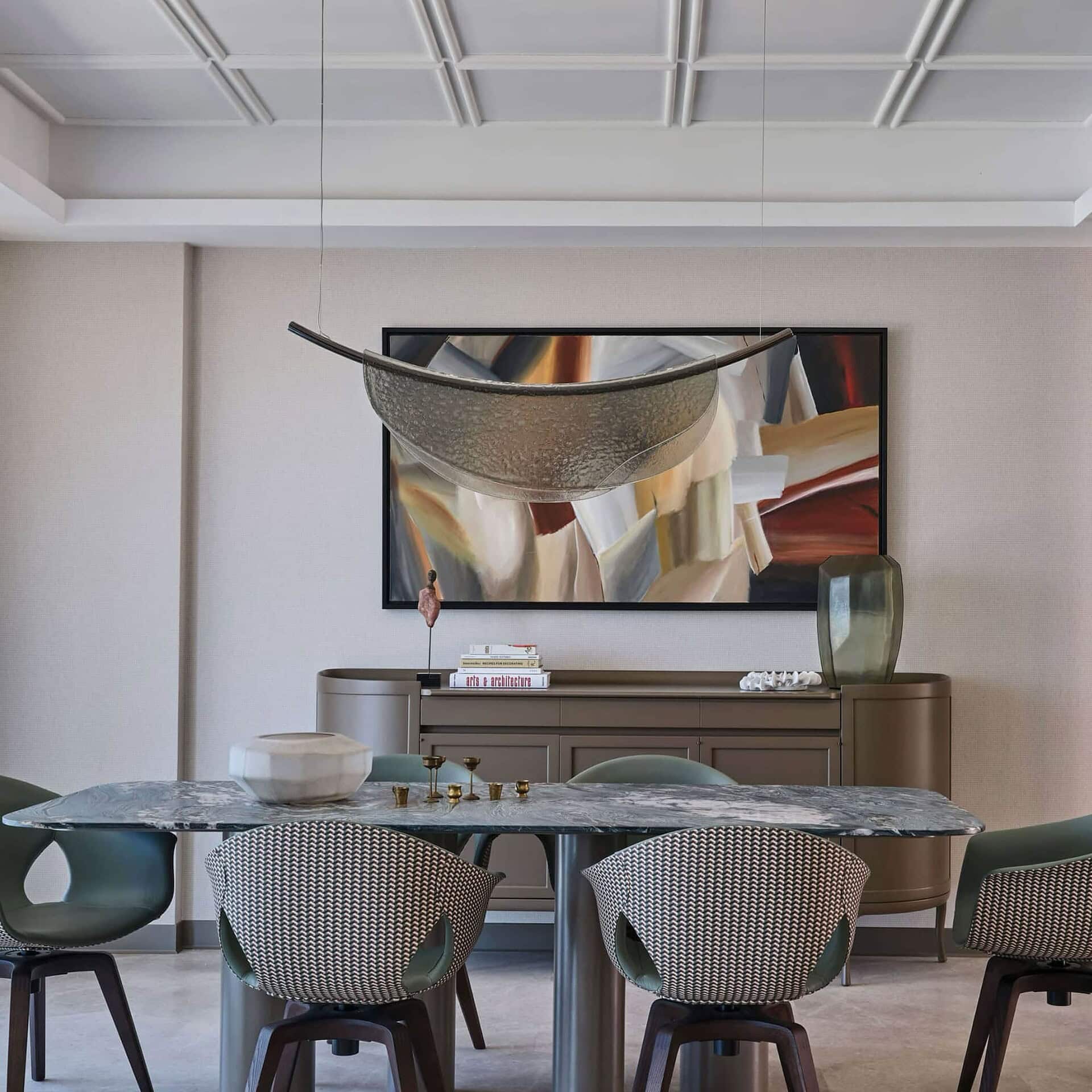 Elegant dining room featuring modern furniture and stylish decor with Sklar Furnishings logo.