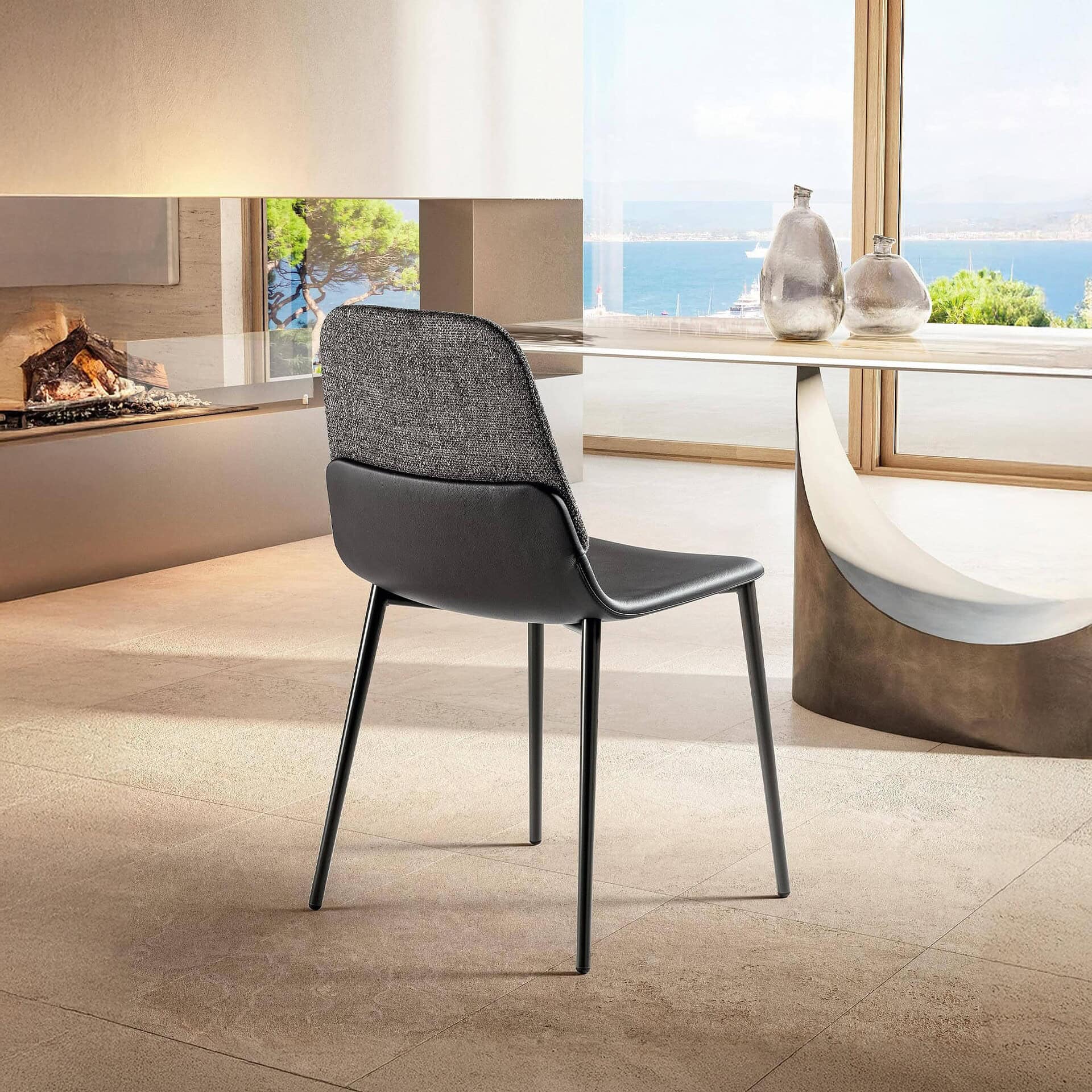 Modern black and gray dining chair with fabric and leather upholstery, stylish and comfortable.
