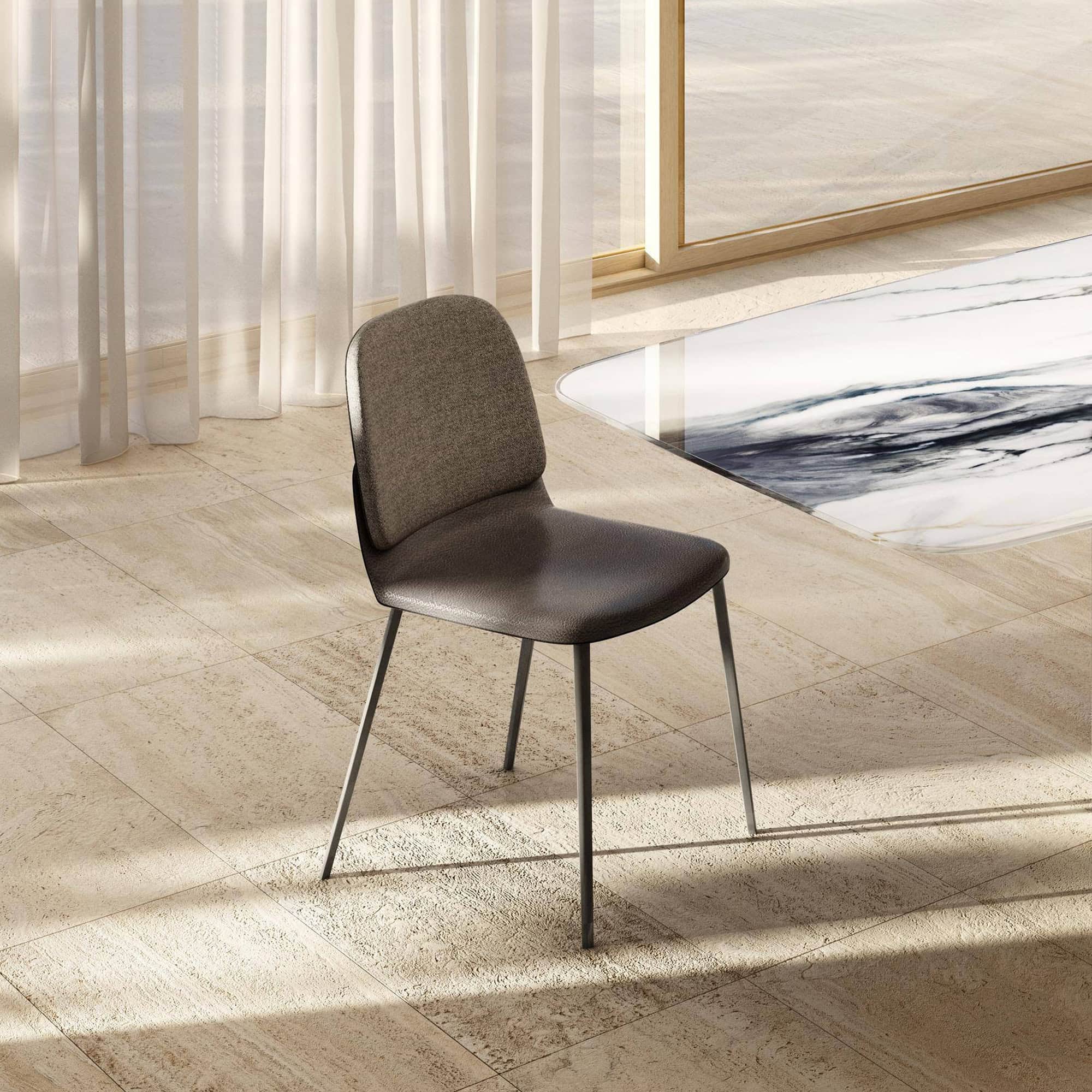 Comfortable modern dining chair with neutral upholstery and sleek black metal legs.