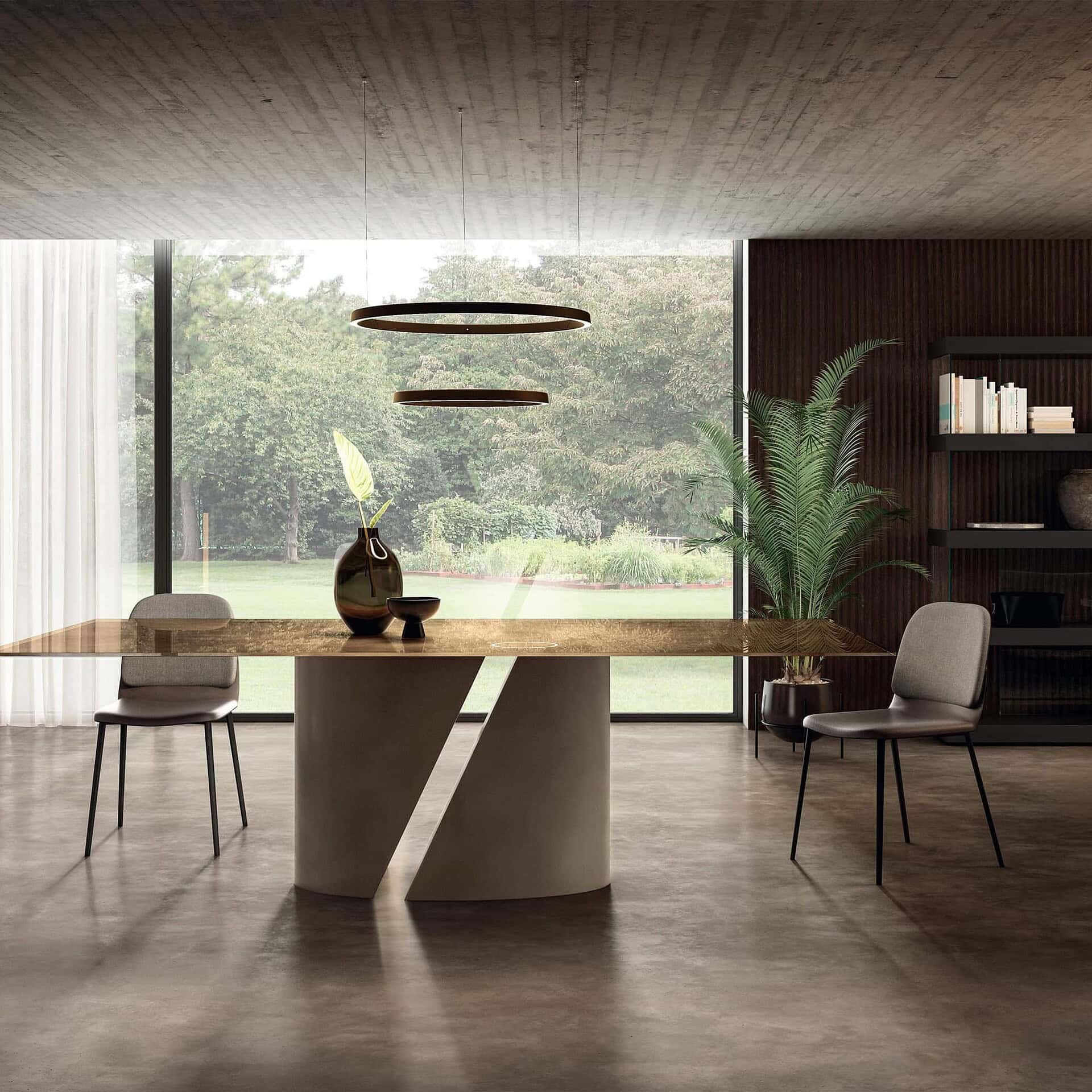 Modern dining room with contemporary table and stylish chairs, featuring large window and greenery outside.