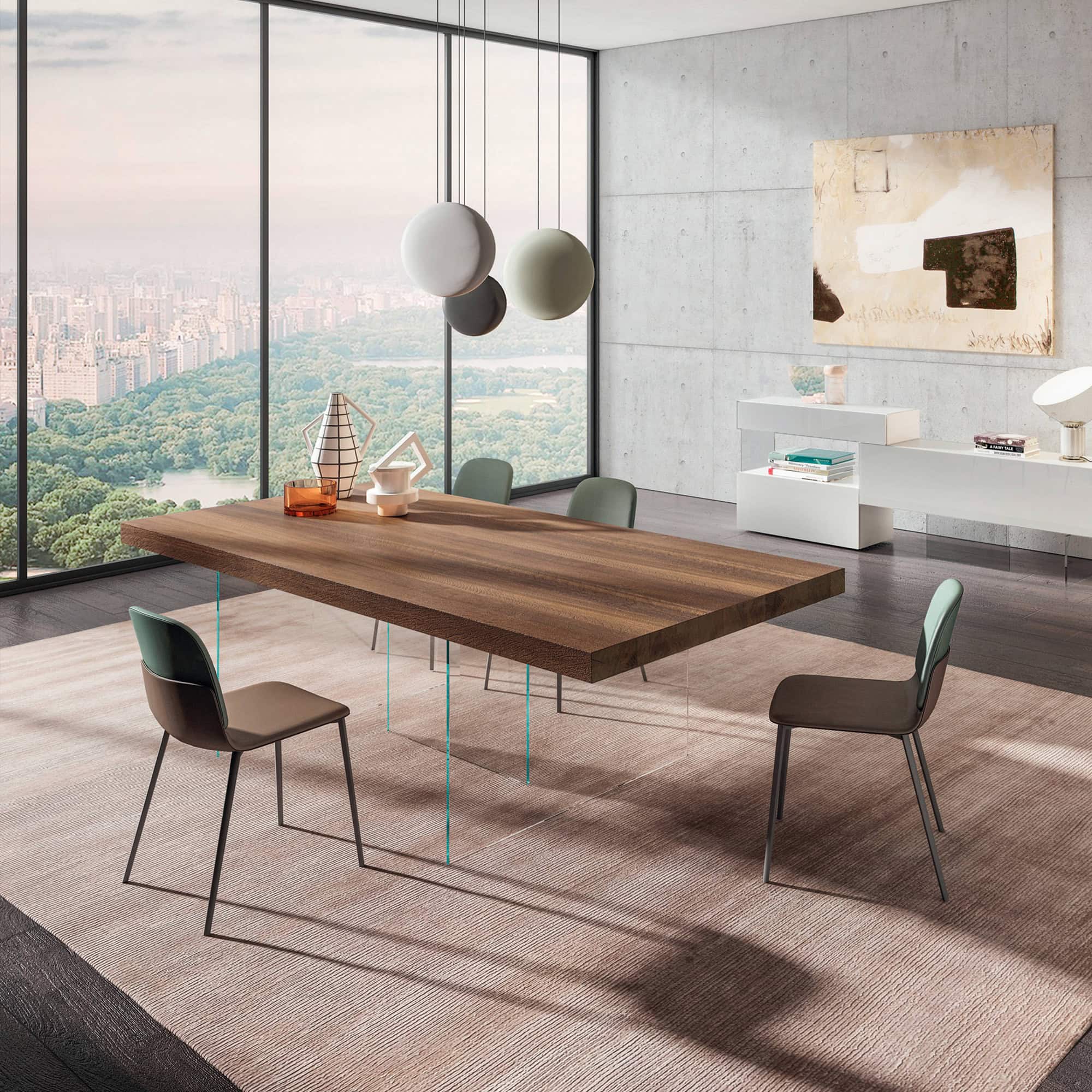 Modern dining room with wooden table and stylish chairs, overlooking cityscape through large windows.