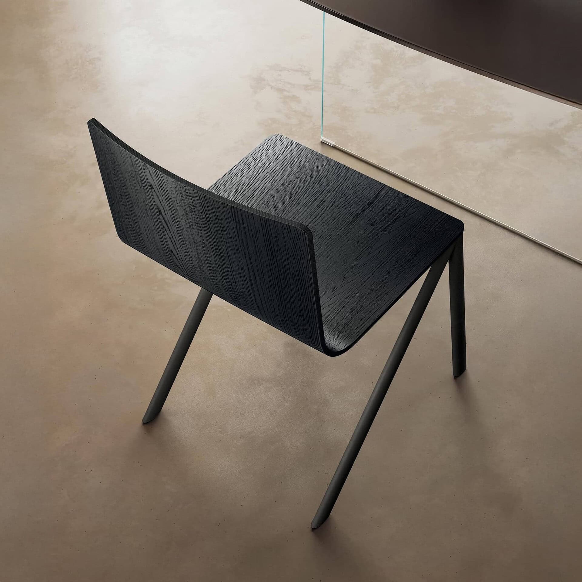 Sleek black modern dining chair with textured wood finish and minimalist design.