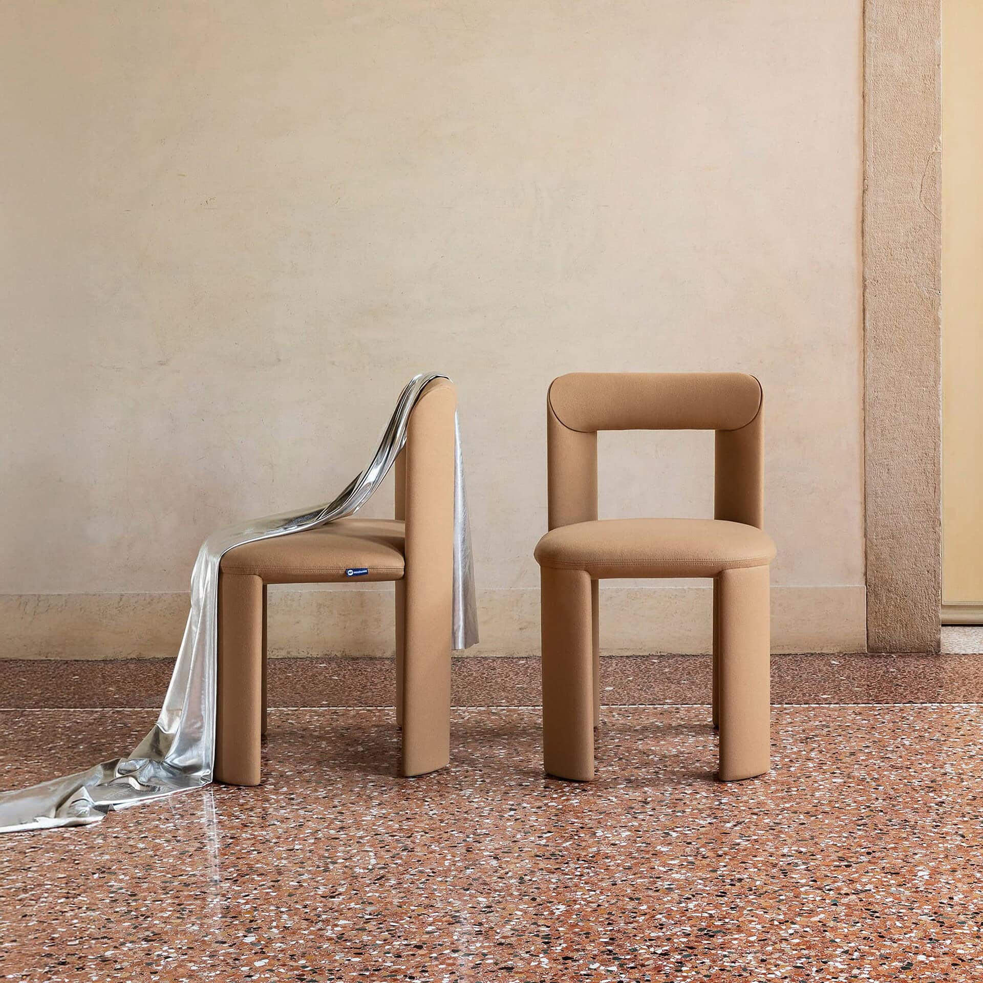 Sleek beige modern chairs with unique cylindrical design for stylish interior decor.