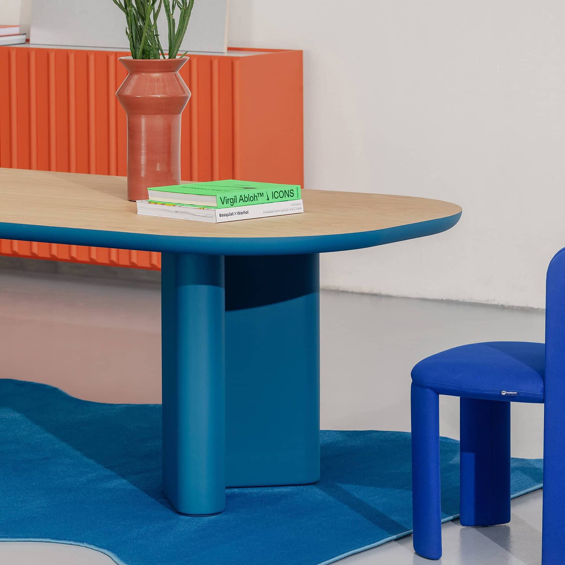 Vibrant modern blue and orange furniture in contemporary office or lounge setting.
