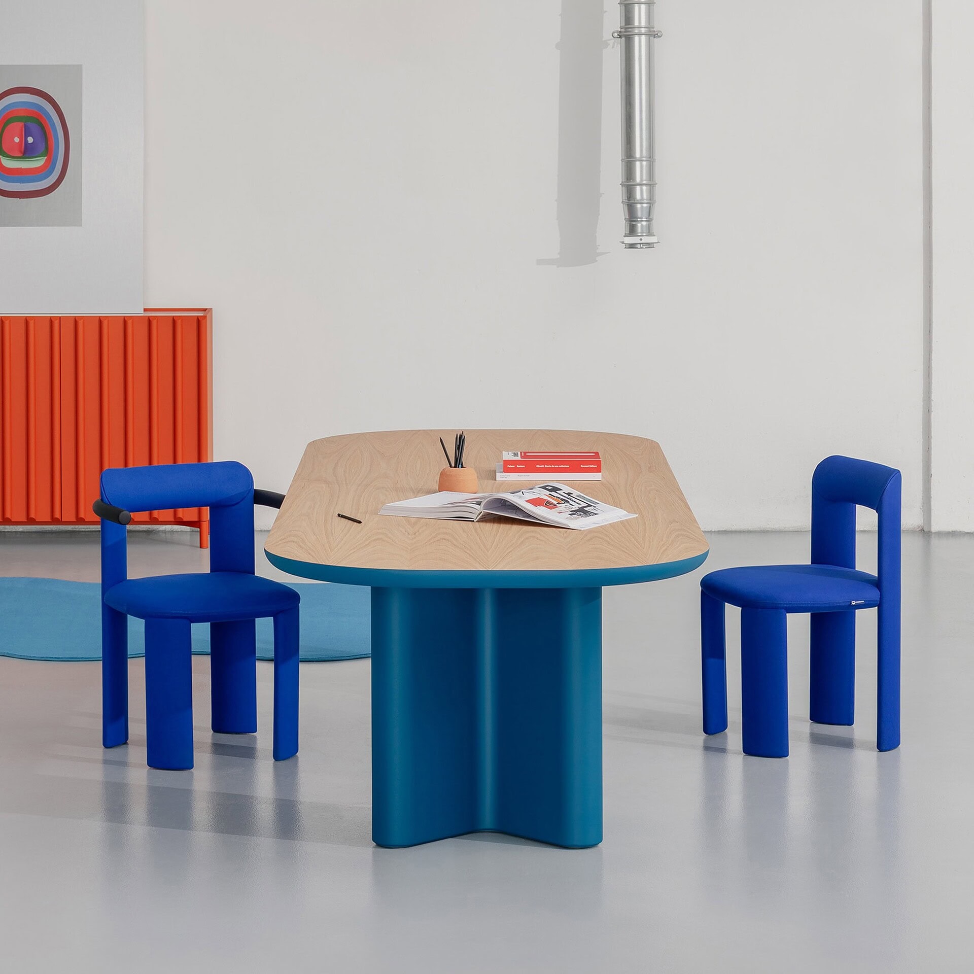 Blue modern dining table with matching chairs and accent pieces at Sklar Furnishings.