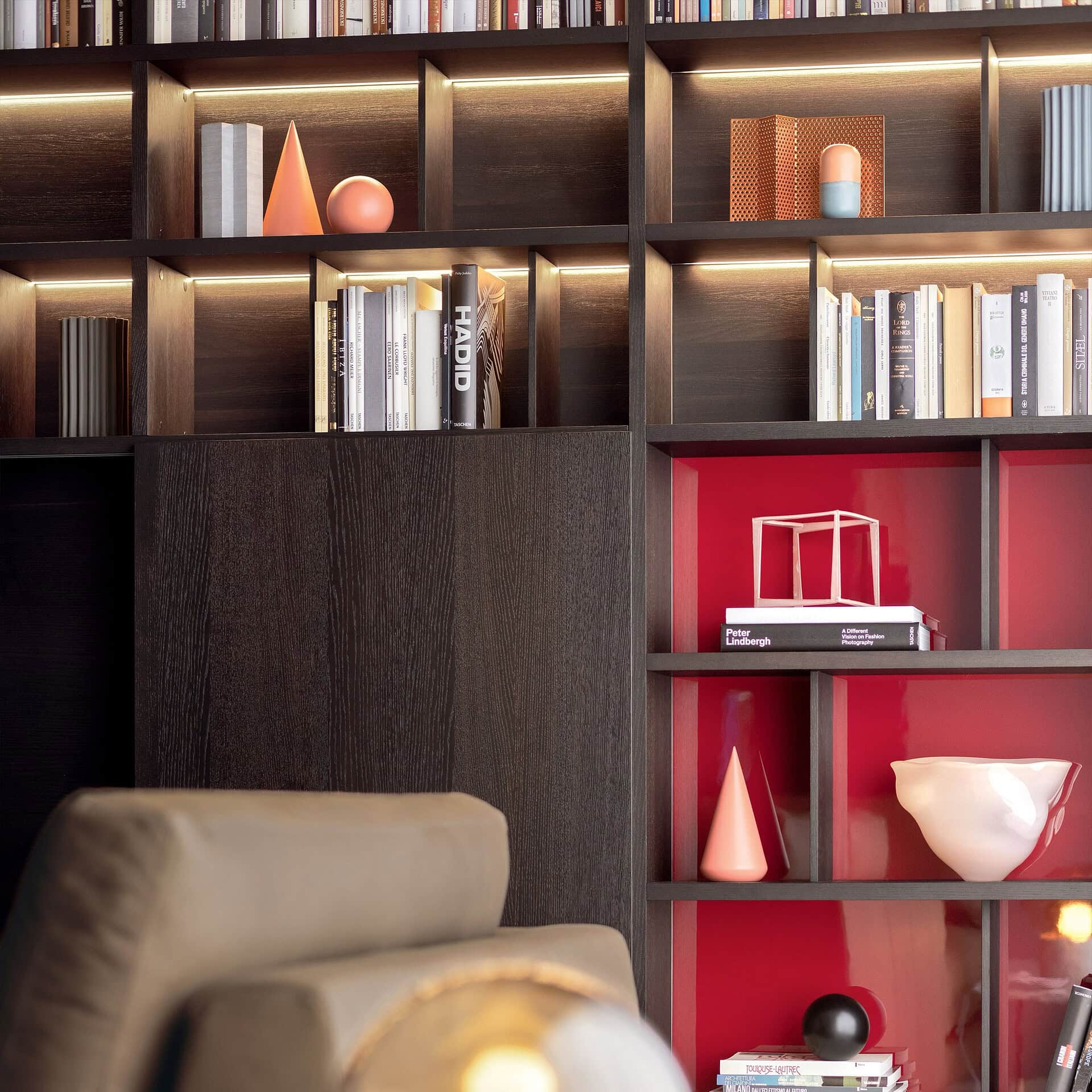 Stylish dark wood shelving unit featuring books and modern decor accents for sophisticated interiors.