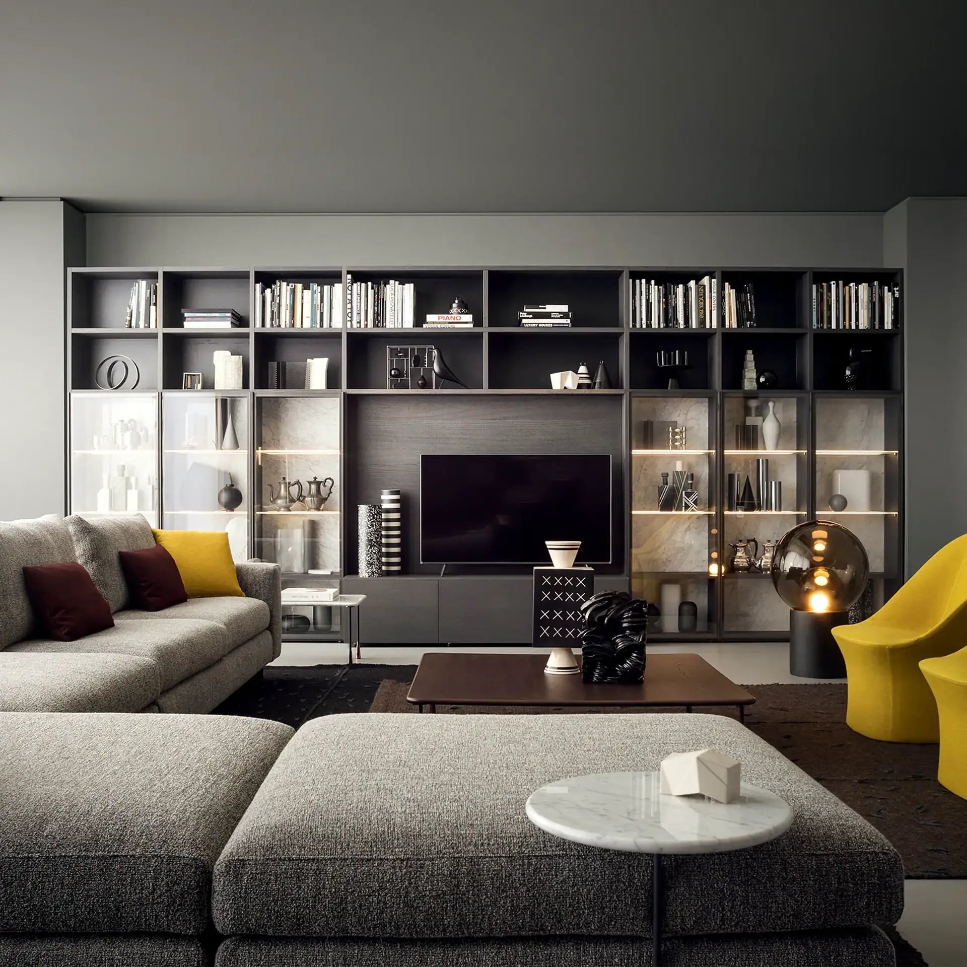Stylish modern living room featuring a large shelving unit with decorative items and a cozy seating area.