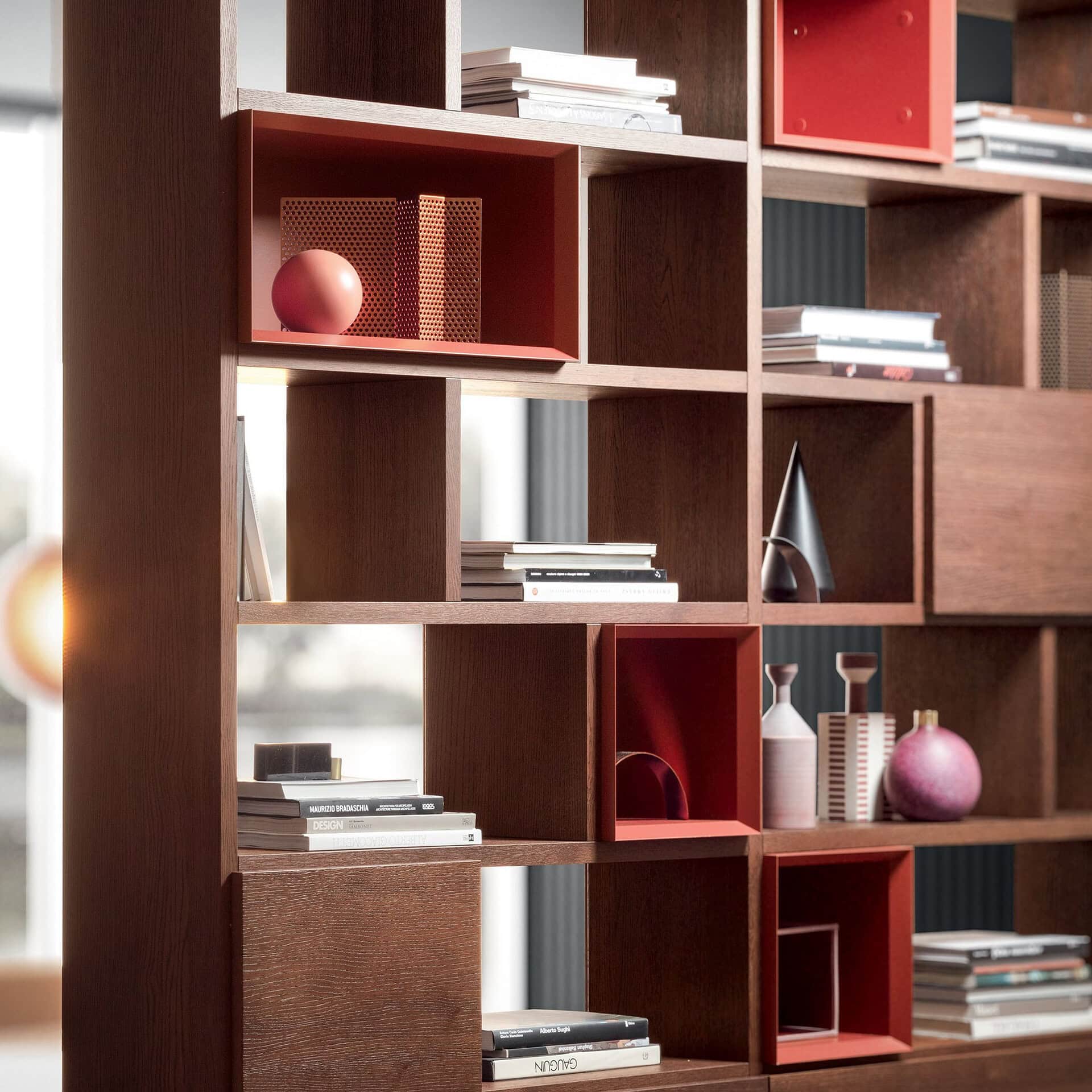Versatile wooden shelving unit with modern decor accents and books.