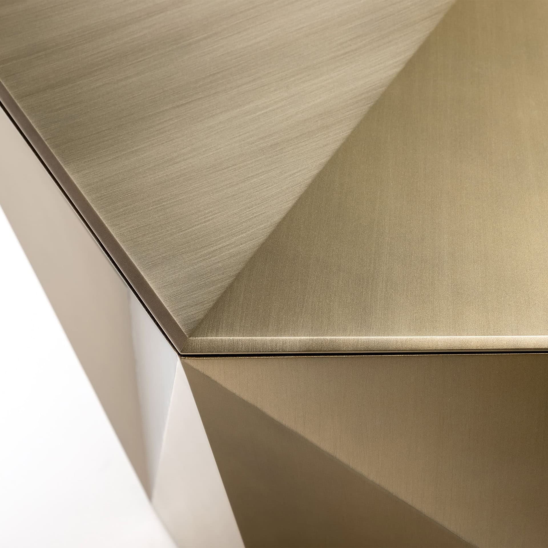 Polished gold metallic furniture corner with sleek, modern design and brushed finish.