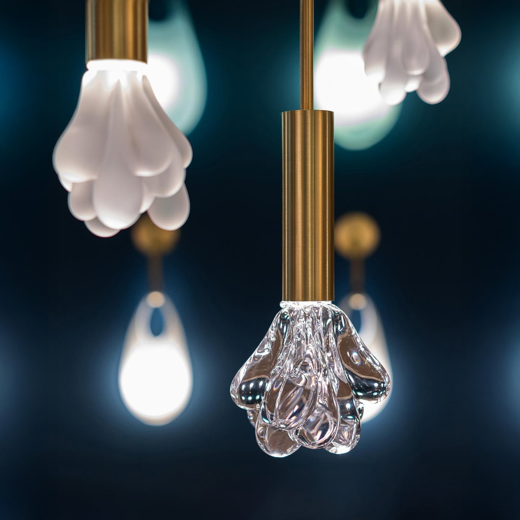 Elegant modern pendant lighting with glass floral shades and brass accents for sophisticated interior decor.