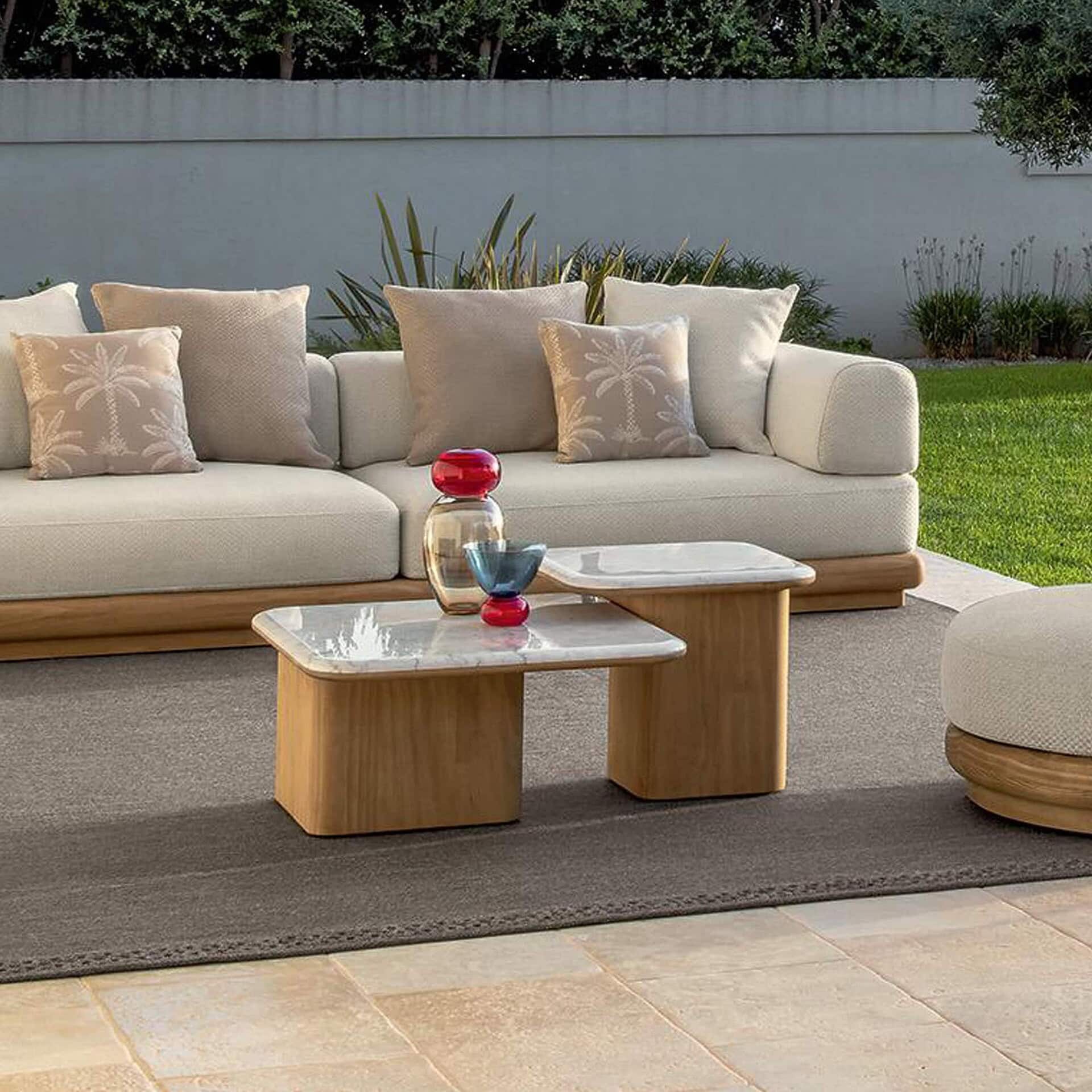 Modern outdoor patio sofa with plush cushions and natural wood accents, ideal for stylish backyard entertaining.