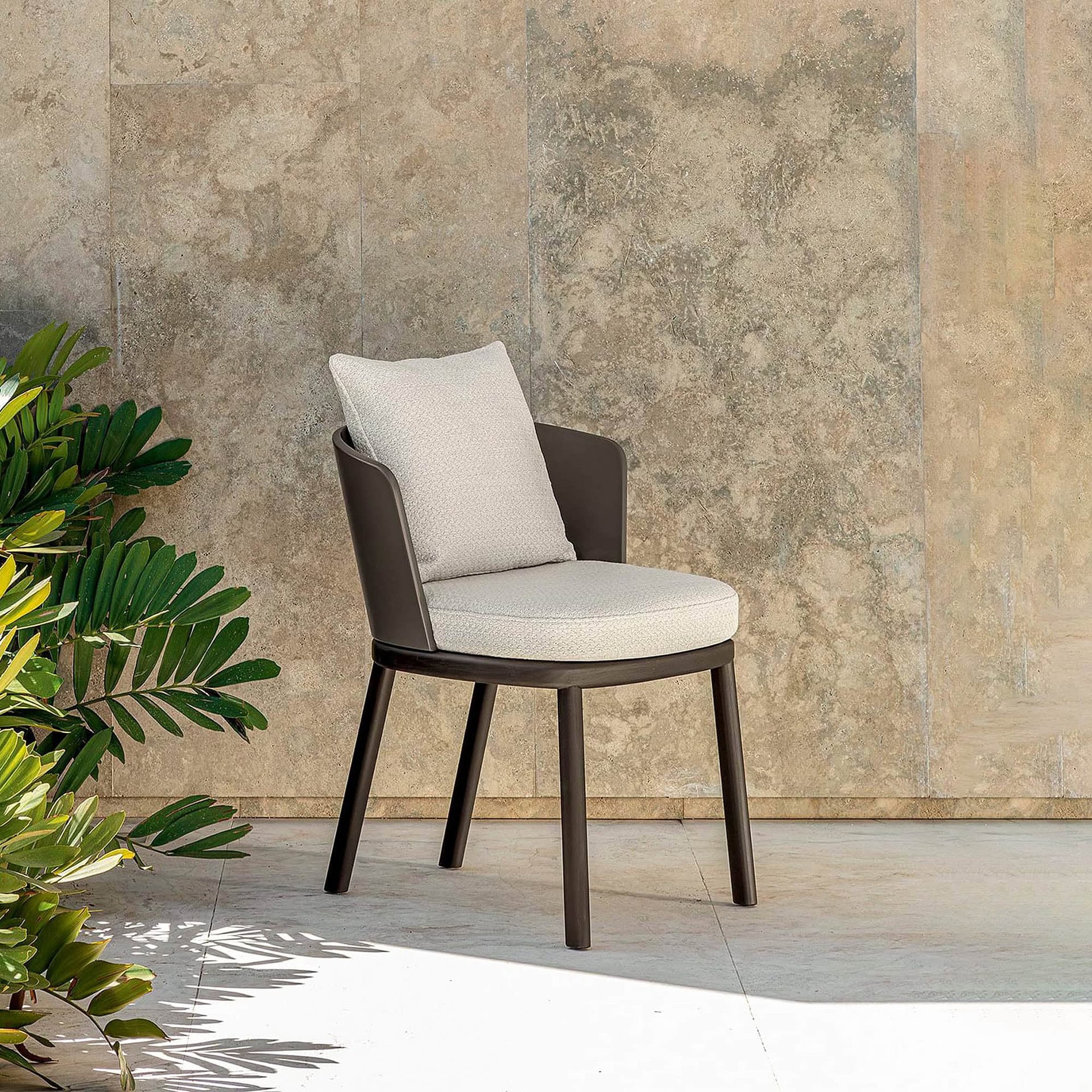 Contemporary modern chair with neutral fabric cushion and sleek wood frame.