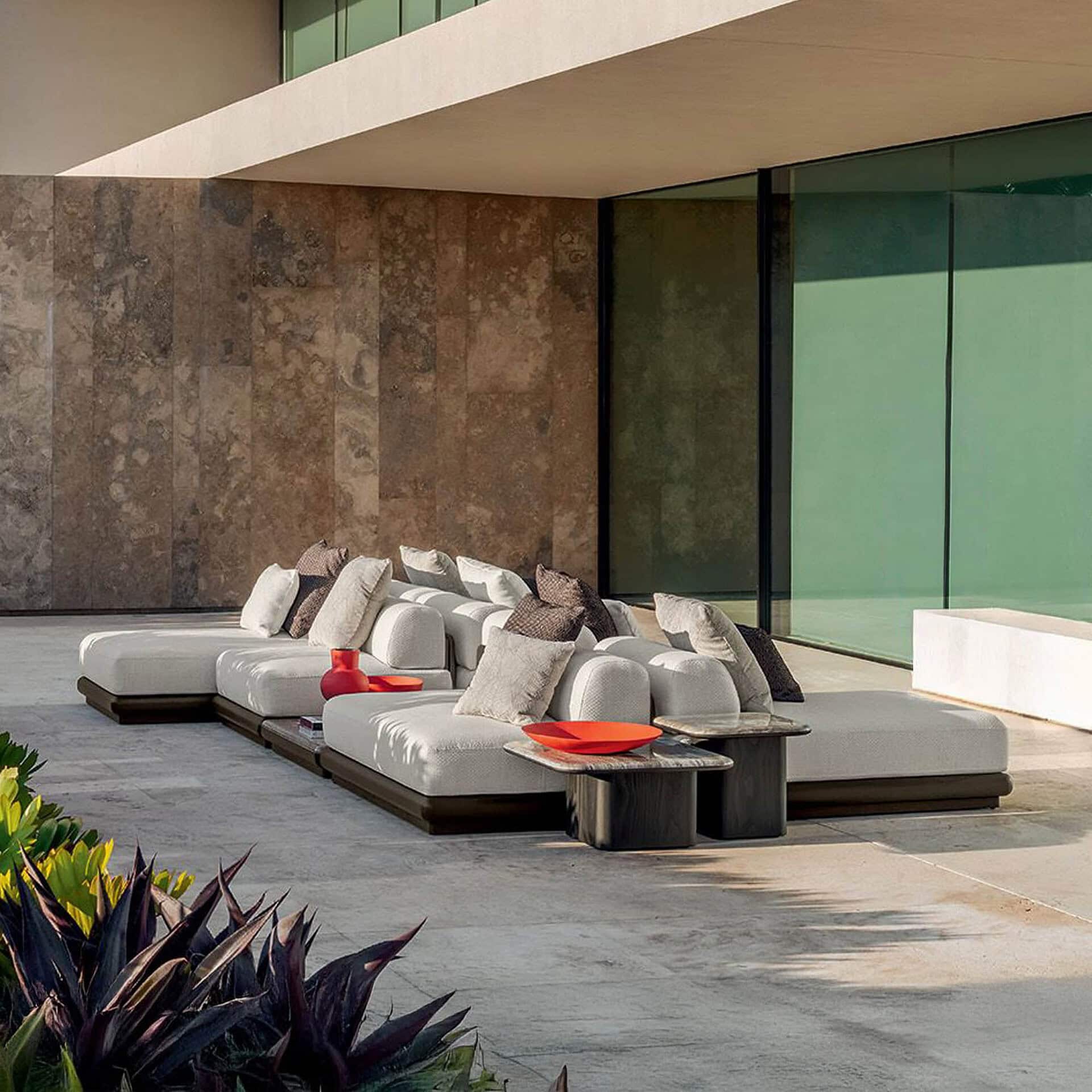 Luxurious modern outdoor sectional sofa with plush cushions on spacious patio.