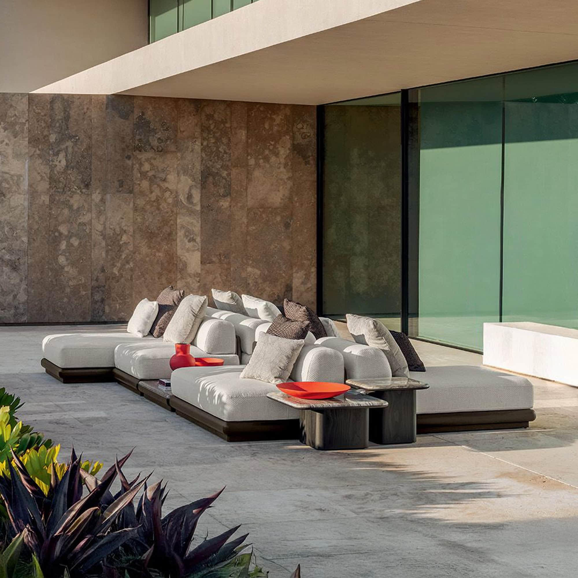 Luxurious modern outdoor sectional sofa with plush cushions on spacious patio.