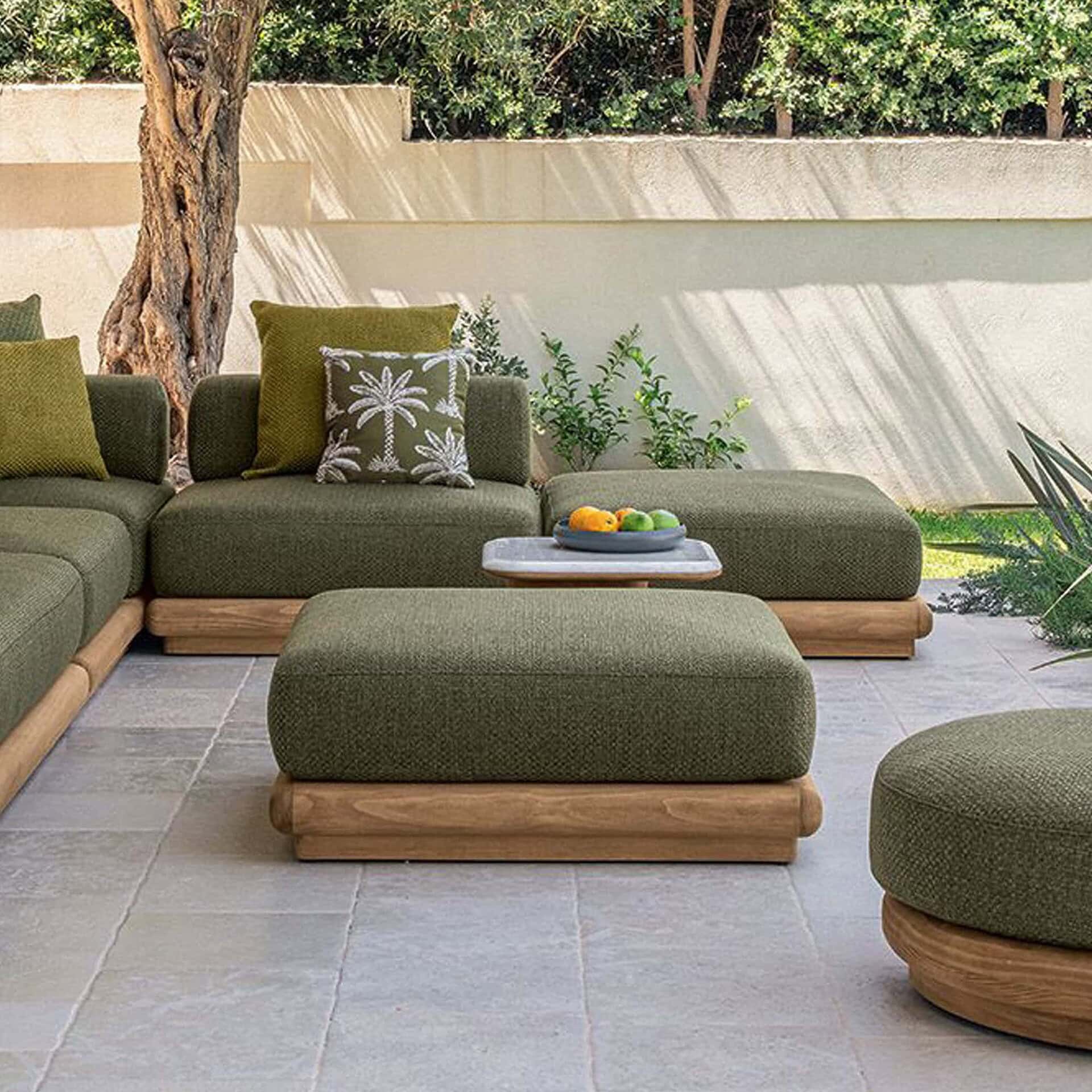 Eco-friendly outdoor sectional with wooden base, comfortable green cushions, perfect for patios.